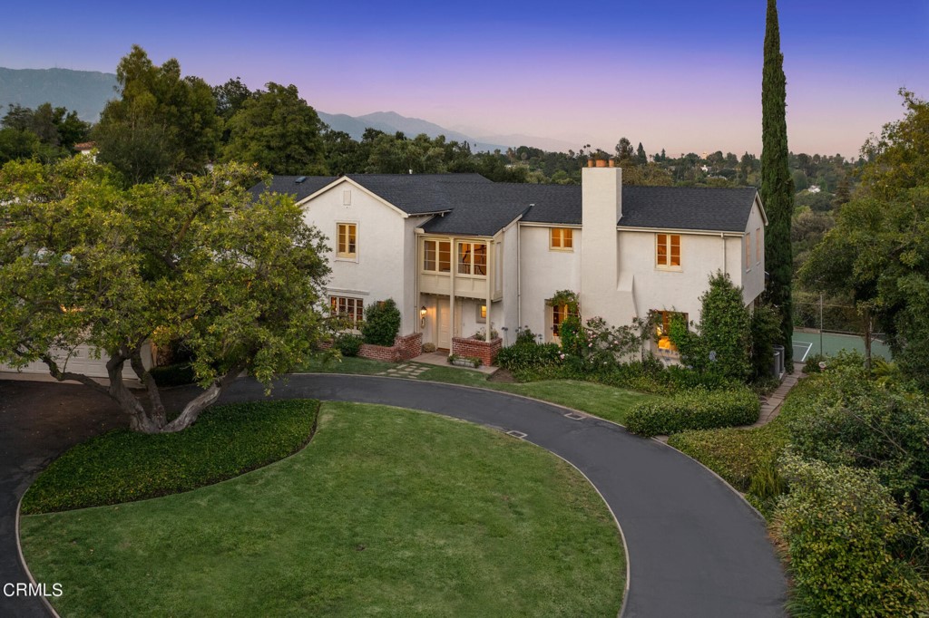 Historic Tennis Court Estate. The Harris Residence: Marston, Van Pelt & Maybury 1924 / Graciously set-back from renowned South San Rafael Avenue and sited to capture arresting views of the San Gabriels beyond, this sophisticated Mediterranean with cues of Regency style from a 1940s enhancement awaits only its fifth owner.Nearly three quarters of a flat acre of sweeping grassy lawn, north/south tennis court, swimmers' pool with bar cabana, changing bathroom and patio loggia - as well as a circular motor court for diplomatic entry -- all set the stage for palatial entertaining.Entry reception foyer, formal living room anchored by a handsome fireplace, and an elegant dining room with pass-thru cocktail nook - all with expansive volumes, crafted moldings, oversized windows and French doors that lead to the fifty foot viewing and sitting room with original terrazzo flooring and glass sliders. Paneled library/den with adjacent powder room. Chef's kitchen with custom cabinetry and breakfast alcove with direct access to a vista-facing veranda terrace. Quintessential indoor/outdoor California living.Upstairs, a flexible bedroom program with two primary bedroom suites accessed from the central landing, two additional bedrooms and an enclosed study/bedroom porch. Three bathrooms.Additionally, first floor service/nanny quarters with a bathroom, and laundry room. Breezeway to the flower room/workshop, as well as two-car garage.