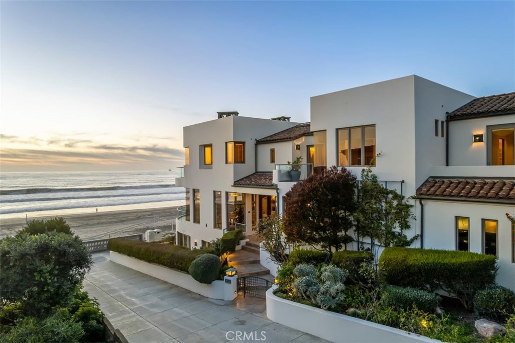 Discover the pinnacle of contemporary beachfront living at arguably the most sought-after location on The Strand. Constructed by renowned builder David Garinger, this residence represents a meticulous investment, emphasizing modern luxury and design excellence.
With over 5,300 square feet of sophisticated living space, this stunning property features five spacious bedrooms and 5.5 bathrooms. The ample parking includes a five-car garage with two elevated spaces plus additional driveway parking, blending functionality with upscale living.
The home’s open floor plan is designed to maximize natural light and embrace stunning vistas of the ocean, Manhattan Beach Pier, Palos Verdes Peninsula, and Catalina Island. Its strategic location benefits from the southern exposure unique to north corner lots, capturing iconic views that elevate every gathering.
Positioned just the right distance from downtown, the location provides an ideal balance of tranquility and convenience—a quick walk to premier dining yet away from the hustle of the city center. This ensures an exclusive retreat that’s both serene and connected.
This home isn't just a living space; it's a statement of style, crafted to impress and entertain. Residing in Manhattan Beach offers a lifestyle of unmatched convenience and community, right at the heart of a vibrant beach scene.
Experience a new era of luxury at one of the most prestigious addresses on The Strand, where design and location converge in a perfect symphony of modern living.