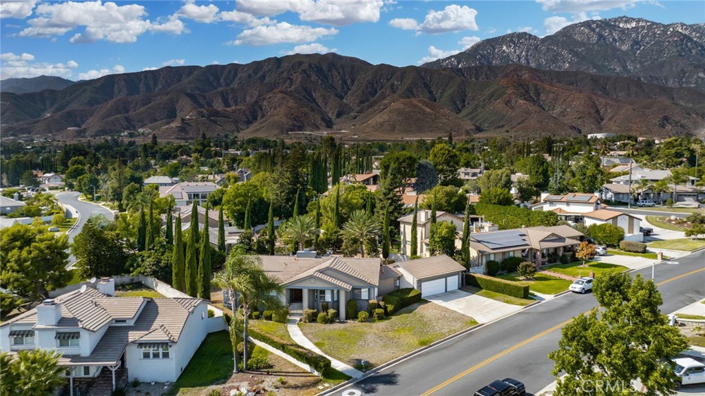 Discover this exclusive San Antonio Heights gem, a single-story home boasting 2,800 square feet of stylish living space on a sprawling 18,774 square-foot lot. The property offers breathtaking panoramic views of the mountains, making it the perfect setting for an ADU addition—ideal for those seeking guest quarters or providing a place for parents to live with privacy while at the same time, being able to participate in family living and staying connected.
Step through the double-door entry into a home adorned with exquisite hardwood flooring throughout. The formal living room seamlessly flows into a generously sized formal dining room, featuring coffered ceilings that create a space well suited for entertaining friends and family—perfect with the holidays approaching. The dining room provides direct access to the kitchen, a true chef's delight. This expansive kitchen opens to the family room and includes a breakfast counter bar, a center island, an abundance of cabinetry, and a cozy breakfast nook. The earthy wood beam ceilings and the warmth of the stone fireplace with a raised hearth in the family room make it an inviting space for relaxation.
The home features three bedrooms, including a romantic primary en suite. Unwind in the luxurious soaking tub or enjoy the shower. The additional two bedrooms are well-sized, with a secondary bath offering double sinks and a tub-over-shower.
The backyard is your private oasis, accessible through sliding glass doors in the family room. A covered view deck provides a perfect vantage point to soak in the stunning mountain views. The expansive backyard also includes a pool and spa, with ample land available for building an ADU or realizing your own dreamy outdoor space. An abundance of fruit trees will amaze you.
Additional amenities include a three-car attached garage, surround sound in the family, living, and outdoor spaces, plantation shutters, and so much more. This home combines simplicity with sophistication, offering a warm and inviting atmosphere with a unique artistic flair.
You will absolutely love coming home to this beautiful property! Make it yours today!