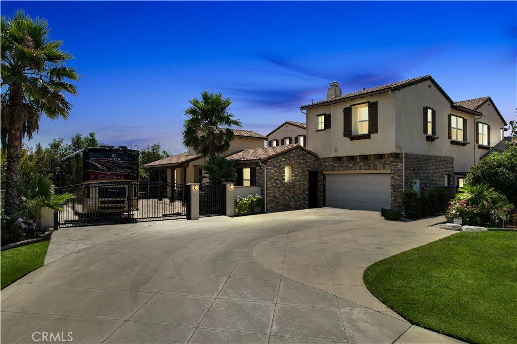 Welcome to Carriage Manor and currently the largest estate available in the beautiful City of Rancho Cucamonga, this magnificent residence is nestled on a quiet cul-de-sac in the coveted Bridlewood Estates community. Set on over a half acre lot, this property boasts 6 bedrooms, 6 baths, and multiple entertainment areas, offering over 6,690 square feet of unparalleled grandeur. As you drive past the private gates, you are greeted by impeccably landscaped grounds that elevate the home's exceptional curb appeal. Stepping through the custom front door, you’ll discover an equally stunning interior showcasing the finest finishes and meticulous attention to detail. From soaring ceilings, exquisite millwork, and rich hardwood floors, every element has been thoughtfully designed. The kitchen, a culinary enthusiast’s dream, with custom cabinetry, natural stone countertops, a butler's pantry AND a wine vault. It seamlessly opens to the family room, offering an open-concept living space. Exquisite crown molding, and trey ceilings enhance the dining room’s refined atmosphere, ideal for intimate celebrations. Afterward, enjoy nightcaps in the sophisticated wine room. The main floor is complete with one bedroom with an en suite bath, convenient for out of town guests. Upstairs you'll find your massive primary suite featuring a large sitting area, fireplace, and walk in closet. Outdoors you can enjoy entertaining guests in the screened-in porch or private courtyard featuring a fireplace, you can truly enjoy your outdoor space all year long. The backyard is complete with a pool and spa, fire pit, a half court basketball, in ground trampoline, still with ample room for sitting and entertaining. Perhaps the best part of this incredible property is the 1,200+ sq ft guest retreat, with private bath and separate entrance. Currently being used as a complete home gym. This could also be used as a living quarter for multi generational families, or even an in-home learning or study area, the option is yours! Every detail in Carriage Manor has been crafted to provide an exquisite living experience, making it a true masterpiece in the Bridlewood Estates community. There are too many special features to list, close proximity to great restaurants and shopping, within the distinguished Etiwanda school district, this rare property is truly one of kind.