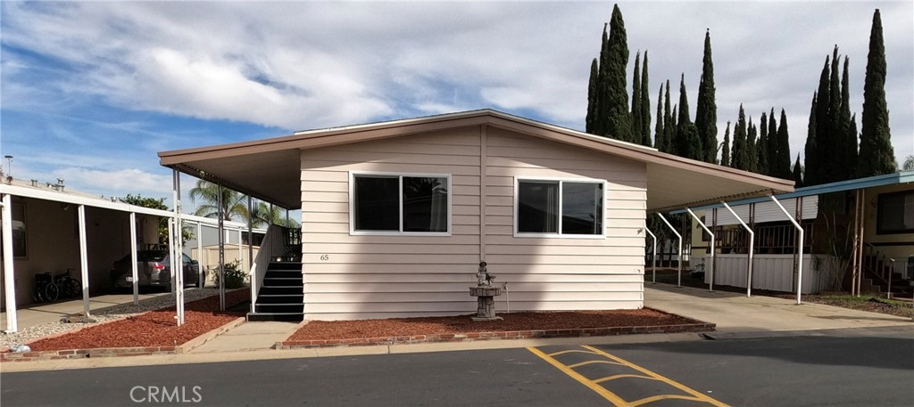 Welcome to Village Riverside an All Age Community in the city of Riverside. A Skyline Manufactured Home with 2 bedrooms, 2 bathrooms, and a den (can be used as a bedroom). The home features an open floor plan, the large living room includes a built-in hutch with an electric fireplace. The remodeled kitchen has new cabinets, new countertops, a new oven/range, a new built-in microwave, and a new refrigerator. The nicely sized bedrooms are located in the back of the home. The master bedroom has an adjoining master bathroom that includes a walk-in shower and a separate bathtub. Additional interior features: recently installed double pane windows, new carpet in the living room and bedrooms, new laminate flooring in the front entry, kitchen, hallway, and laundry room, new vanity in bathrooms, new fixtures, ceiling fans, and a laundry room with washer and dryer hookups. Additional Exterior Features: shed wired with electricity and work bench included, new exterior paint, and low maintenance yard. The home is also equipped with heating and central a/c. The owner will include a 1 year home warranty and (3) wall-mounted flat-screen TV's……Don’t let this home pass you up…….
