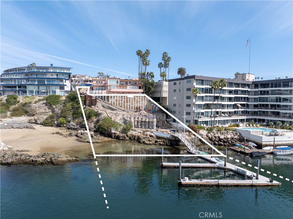 This is a genuine once-in-a-lifetime opportunity to acquire the finest bayfront parcel in Corona del Mar. Set on a sloping bluff cascading down to its private cove, this property affords unequalled panoramic views of the harbor, ocean, Catalina and sunsets from its elevated pad area. Included in the offering are the initial phase of construction improvements (grading, shoring, and extensive new foundation construction). Now the project is ready for a new owner to step in and complete the construction of the spectacular contemporary home of 7,270 square feet that was designed by renowned architect Chris Brandon. From the moment one steps inside the two-story entry hall, the new home when completed will feel as though it is floating above the cove and harbor below. Extraordinary ceiling heights complement spacious rooms in the open plan. Floor-to-ceiling walls of glass bring the out of doors in, making the home at one with its scintillating setting at the water's edge. Several outdoor terraces, an entertaining cabana, elevated infinity pool and private gardens will complete the home. Also included in a massive private dock with accommodations for several water craft. Over ten years in the making, this was an extraordinary undertaking to plan and receive permits to build; permits that would not likely be granted again. The construction, too, required the very best team to bring it to life. With the "difficult" part of the project now complete, a new owner will be able to create the home of their dreams in a relatively short period of time.