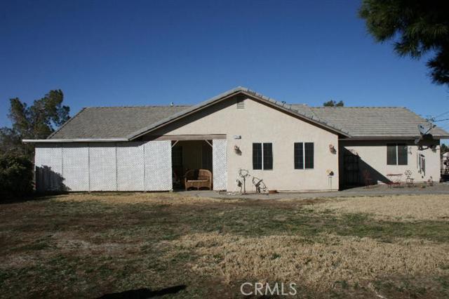 Looking for a beautiful home, look no further. This home is move in ready. This beautiful 3 bedroom, 2 bath home with an upgraded kitchen. This property also has a 25x50 workshop along with two storage sheds. For those golfers there is an putting green in the backyard. This beauty has it all. Association Amenities: None # of RV Spaces: 0 Special Features: ,PTRY,SH,WK,OBNONE Frontage Type: Dirt Road Lot Location Type: Standard Location Landscaping: Sprinklers, Full Special Features: Garage Door Opener # of Attached Spaces: 2 # of Detached Spaces: 0