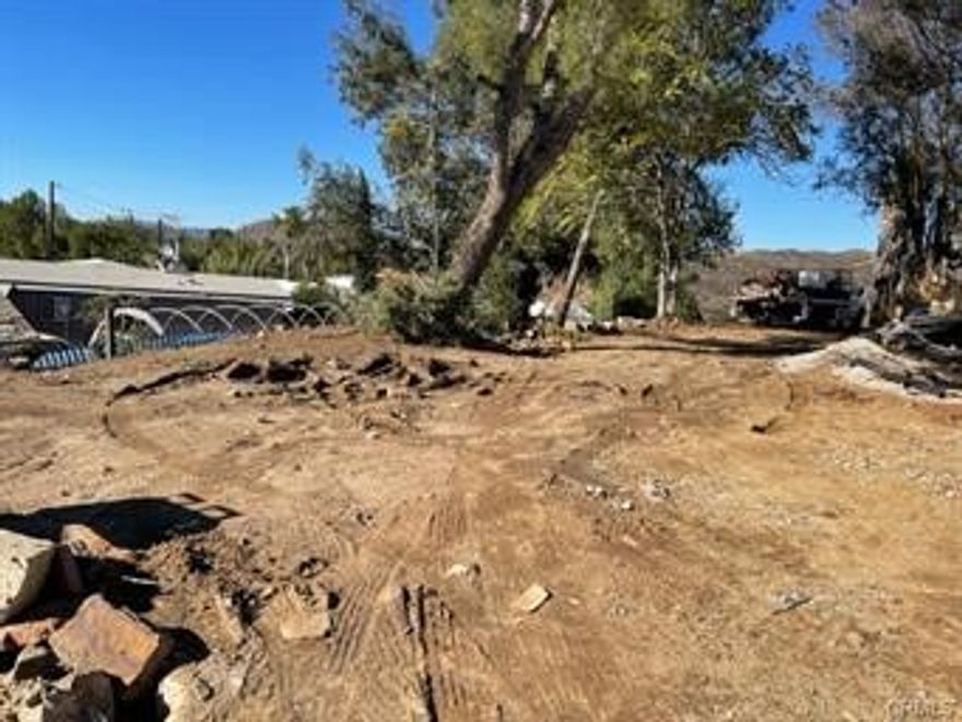 Nice lot for your Manu Home? on a nice lot in Wildomar and only a stones throw to Menifee. Lot is approximately 50' x 100'. It is a two level lot with potential home sitting on the top right of lot with GREAT VIEWS of the soft mountains nearby. The driveway level is at street level. This is a great value lot for the money with utilities at the property line. This lot does not include hookup expense. There  may be an existing septic tank on site.  Public water and electricity overhead.  There is possible owner financing with 25% down.