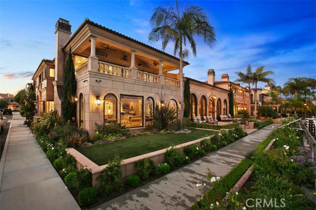 One of a kind skilled waterfront-specific design, construction, for maximum bay views, privacy, and durability in coastal climate distinguish this light-filled open Mediterranean masterpiece 9,633 sq ft 6 bd 8 ba Naples Island home. Formal entry is via Vista del Golfo Promenade flanking property’s 120 ft of private dock frontage directly facing entrance to Alamitos Bay:5 sets of 10-ft tall arched glass doors open above Promenade into enclosed secure 726 sq ft Veranda w/14-ft groin vaulted ceilings. It leads to Grand Hallway w/ 22 ft ceilings and domed skylights, a dramatically beautiful conduit between formal living, dining areas, library, and casual bayfront Great Room, and links to 2nd floor via Juliette balconies, balustrades, and 2 curved stairways. 1st level also has spacious view gourmet kitchen w/ streetside door, elevator, 1-car and 2-car garages, laundry, maid’s room, 2 baths, fossil stone bar nestled at foot of stairway, and private courtyard w/ self-swim spa disguised as a lovely garden fountain. 2nd floor has Master Wing with large bay view deck, his and hers master baths and closets, office, home theater, 2 ensuite guest rooms, exercise room and 2nd master suite. Superior quality stone, wood, wrought iron, and leaded glass details throughout.