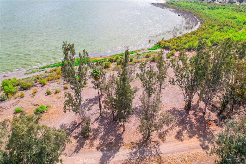 Where else are you going to find 5 acres right on the lake with fantastic views and beautiful mature trees! Panoramic views of the lake, hills and city lights. Bring all of your water toys! The lake offers activities of fishing, stand-up paddle-boarding, kayaking and so much more. All right here in the action sports capital of the United States. Such heart pounding thrills like wakeboarding, wake surfing, water-skiing and tubing! You can do it all on Lake Elsinore. Desirable location near downtown, shopping and restaurants! Just over the hill from Dana Point and the Pacific Ocean. The City of Lake Elsinore has 19 parks with amenities that include world class tournament facilities, three skate parks, a BMX pump track, four dog parks, two splash pads/ spray parks, numerous picnic shelters, ball fields, hiking trails, playgrounds, fitness tracks, a golf course and plenty of open space areas. Utilities at the street.