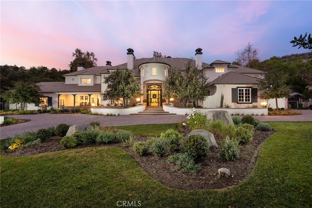 Welcome to 30881 Via Colinas, an elegantly designed equestrian zoned estate home in the exclusive guard gated community of Coto de Caza. Sitting on 5 acres and boasting nearly 10,000 ft.² of living space. As you drive through the private gate and up the long driveway, you will see how secluded and private this property truly is. Built by Stonefield Development and reimagined by Brook Wagner Design, the main house features 7 bedrooms/9 bathrooms, each bedroom with its own en suite bathroom. Upon entering you are greeted by soaring ceilings, an abundance of natural light, and a stately dual staircase. The light and bright chefs kitchen has high end stainless steel appliances, elegant marble countertops, floating shelves, and a breakfast nook. The kitchen opens to the family room and game room / bar area, offering the perfect space for entertaining and relaxing. The Game room features a temperature regulated wine room. Downstairs you will also find a guest bedroom, oversized laundry room, office with detailed mill work and coffered ceilings, and crafting room. Upstairs, the primary wing features a spacious bedroom and retreat with views of both the mountains and the backyard oasis. The primary bathroom has no detailed spared, with a sauna, walk in closet, large walk-in shower, and standalone tub. In addition to 4 secondary bedrooms, there is a junior suite with a back staircase allowing for easy access. The designer lighting throughout serves as the perfect accent. Conveniently this incredible home also has an elevator. The attached six car garage has finished floors and an ample amount of storage. The detached guest house has a state-of-the-art movie theater, golf simulator, and, for the car enthusiast, an additional 6 car garage. The grounds are breathtaking! Enjoy the pool with slide and waterfall. The outdoor room has a two-sided fireplace, pizza oven, BBQ and several sitting areas. The lower yard also has a raised bed garden, large grass area, gazebo sitting area, fire pit, & animal enclosure ideal for chickens or goats. The upper yard has a putting green & batting cage. There is plenty of space for parking larger vehicles such as RVs, boats, etc. Other amenities include smart home capability with Control 4 and Lutron controlled lighting, in door and outdoor speakers, top of the line water filtration system, and much more. No expense has been spared in the extensive remodel! Don’t miss the chance to make 30881 Via Colinas your home.