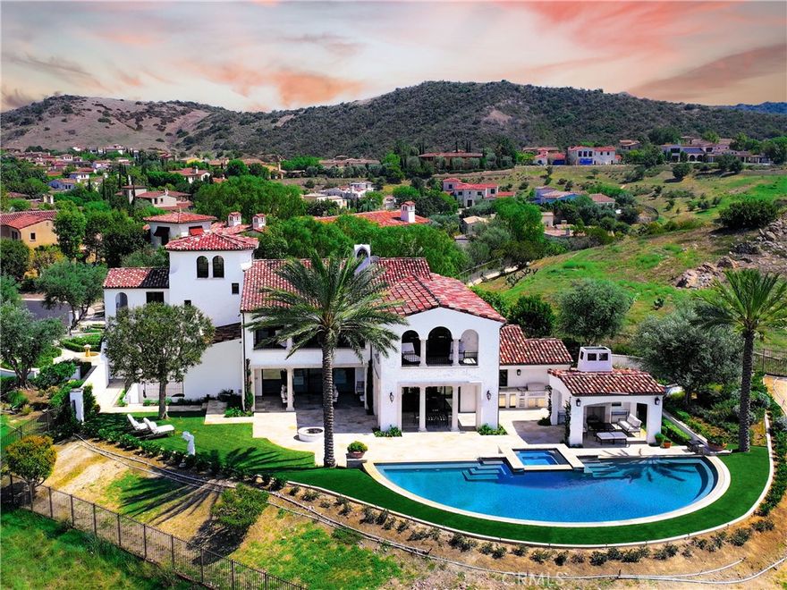 Situated on one the best view lots in the ultra exclusive guard gated community of Shady Canyon, 20 Black Falcon will absolutely take your breath away. From the moment you step into this trophy estate on one of the area’s most elevated vantage points, you are enveloped in an unrivaled endless vista that is both inspiring and spectacular. Located on a private peninsula-style parcel (boasting unparalleled privacy), the intelligent floor plan accentuates the breathtaking views from nearly each and every room of the property. The presence of city lights and absence of rooftops in one's view-line creates a sense of connection and enjoyment that few homes ever offer. One of coastal Orange County’s crown jewels, this one-of-a-kind residence, stretches over ~10,934 sq. ft., boasts 6 spacious bedrooms and 10 baths all set upon an expansive ~23,392 sq. ft. lot. Every inch of this recently renovated home has been crafted with the finest materials and detailed precision. As you step inside, be captivated by the soaring beamed ceilings, a spiral staircase that serves as a central focal point, and an open floor plan that fluidly connects the living spaces—all presenting panoramic views of city lights, Palos Verdes views, the rolling hills, golf course and the ocean. The heart of the home, a chef’s dream kitchen, is equipped with top-tier appliances and offers a full prep kitchen as well. The open-concept space ensures you're never far from the vibrant views, whether you're dining at the breakfast nook, lounging by the family room, working in the kitchen, or making a libation at the bar. The tastefully designed interior boasts an elevator, walk-in pantry, elegant wine cellar, state-of-the-art home theater, gym/spa, and sauna, beckoning an elegant lifestyle. Bedrooms, especially the primary suite with its dual walk-in closets and spa-like bath, exude tranquility. For those who seek entertainment, the state-of-the-art home theater, game room, and a bar with built-in features cater to every indulgence. Outside, entertain in style with an outdoor kitchen, BBQ area, and an awe-inspiring infinity pool that melds seamlessly with the horizon. All of this is framed by the backdrop of the Pacific, creating an ambiance that's truly out of this world. 20 Black Falcon isn't just a home—it's a testament to luxury living, where every detail has been meticulously curated. This is more than real estate, its elevated living at its finest.