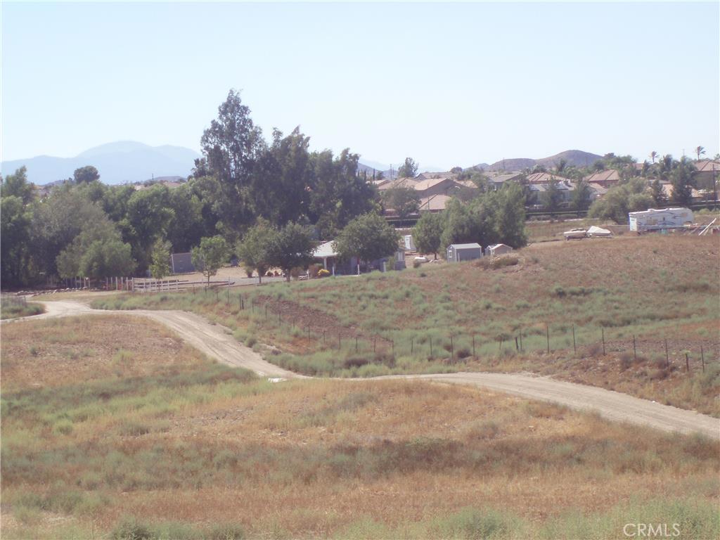 gentle rolling 5.76 acre corner lot barely off Scott Road, utilities in street, perfect parcel for horses, custom/manufactured home. Great investment for the future in high growth area.