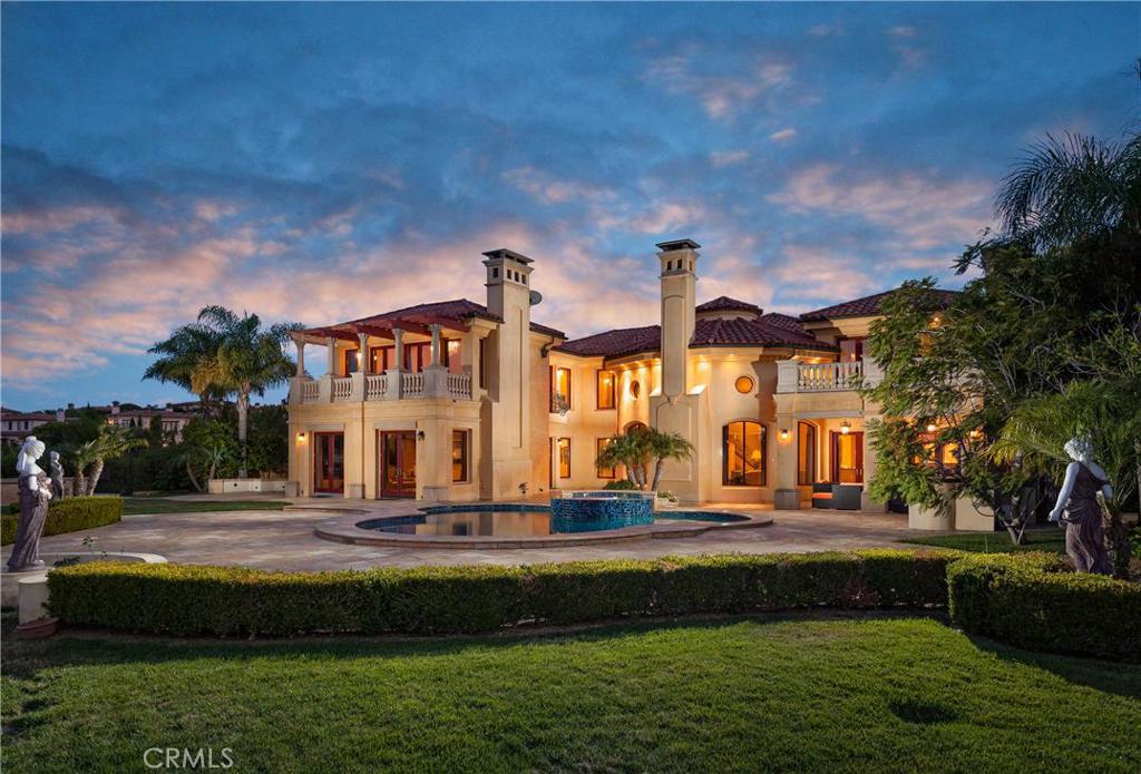 Incredible opportunity awaits with this stunning guard-gated Pelican Crest estate set on an extra large flat lot with expansive views and partial ocean view. An exceptional property both inside and out, the timeless elegance comes alive with the luxurious finishes throughout and the finest in custom craftsmanship.The interior is rich in details from the custom moldings to the Baccarat chandeliers; and to the exquisite iron work and bold use of stone. Upon entrance, experience the grandeur with the dual staircase, marble flooring and hand painted walls. Perfectly set on the lot, the front offers a gated auto court with four car garage and a walking veranda with the rear of the home encompassing the ultimate in luxury getaway with an outdoor "California Room", pool, spa, fire pit, built-in barbecue and expansive terrace spaces. Situated as the best value in Pelican Hill and Crest, this truly is a must see.