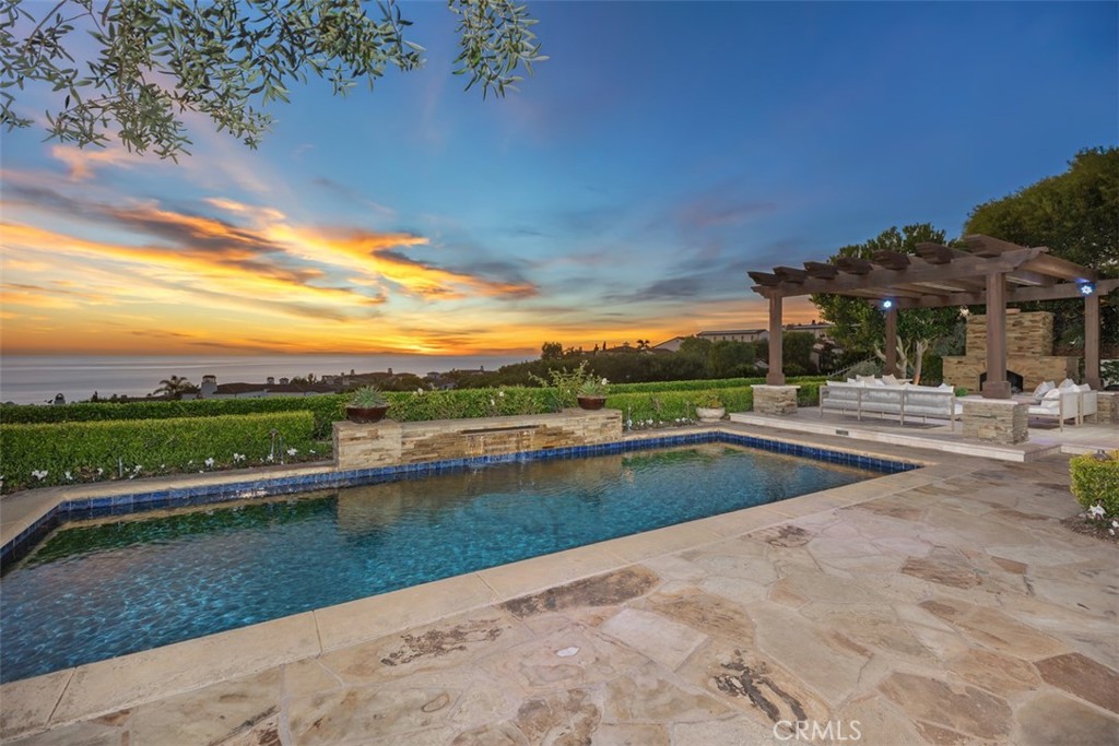 Exquisitely move-in ready, this exceptional 5,045 sq. ft. residence is set on a private 13,871 sq. ft. lot on one of Crystal Cove’s most coveted ocean-view cul-de-sacs. Recently reimagined with luxurious, contemporary finishes, the home features elegant white oak flooring, exquisite stone countertops, and custom lighting that together create a harmonious, sophisticated design. The expansive, thoughtfully crafted floor plan includes up to five generously sized bedrooms, a chef-inspired gourmet kitchen, a media room, and versatile spaces for both intimate gatherings and formal entertaining. Step outside into the serene, resort-style backyard, where lush gardens, a raised viewing platform, and a stylish covered cabana with a cozy fireplace set the stage for the ultimate outdoor living experience. The state-of-the-art outdoor kitchen, equipped with a top-tier grilling area, complements the tranquil saltwater pool, creating a true private oasis. Panoramic ocean vistas stretch out before you, with unobstructed views of Catalina Island and breathtaking sunsets, offering a rare combination of privacy, tranquility, and natural beauty. For added convenience, the home includes a three-car garage and an oversized driveway with space for up to seven vehicles, ensuring ample parking while maintaining an exclusive feel. This property is the epitome of coastal luxury, combining both privacy and convenience for a lifestyle like no other. Beyond the residence, residents enjoy a host of exceptional amenities provided by the HOA, including playgrounds, parks, and 24-hour guard-gated and patrolled security. The exclusive Canyon Club offers unparalleled privileges, including tennis, pickleball, basketball, swimming, fitness, and banquet facilities. With world-class shopping, dining, and the renowned beaches of Crystal Cove just moments away, this remarkable home offers the perfect blend of coastal living and modern convenience. 14 Gondoliers Bluff represents a rare opportunity to fully embrace the quintessential Newport Beach lifestyle.