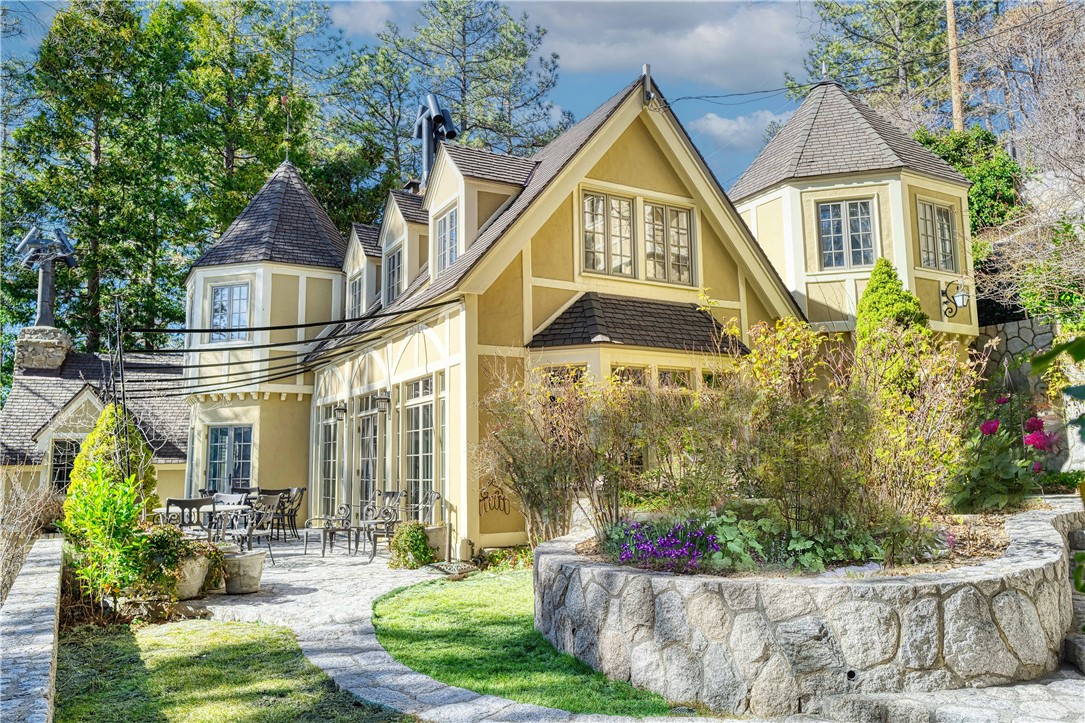 An Era Gone By... It is not often that one of Lake Arrowhead’s premiere and historic Lakefronts becomes available! This ‘Circa 1925’ Fairytale Stone Lakefront Cottage is its own private compound with stunning outdoor intimate spaces filled with glorious roses and shrubs and trees, assuring total privacy. There are glorious stone walls protecting its privacy and a meandering path leading down to the sparkling Lake Arrowhead Waterfront to the ‘Double Canopied Dock and Dock House.’ An electronic car gate allows for easy level entry to the Residence. There is a 4 Car Deep Garage with level access. The ‘North Shore’ is one of Lake Arrowheads premiere locations, as back over 90 years, these magnificent properties were sought by Hollywood Celebrities and famed Executives and this custom Stone Cottage has been noted as the ‘Bullock House’ and the probable Owner or Builder. The present Owners have impeccably restored and maintained the Residence for 30 years! Step into another world: 4 Bedrooms, 4 full Bathrooms and half Bath, Master Lounge has Fireplace and Office in the Main Residence. The Kitchen is modest and combines with circular Dining Area. Sweeping Staircase. Intimate Living Room with Fireplace. Dining area will seat 8 to 10 comfortably. Canopied Veranda! The property includes 2 separate Guest Apartments each with Fireplaces. The Upper features 2 Bedrooms, Bathroom and Full Kitchen / Lakeview. The Lower is a Suite with Fireplace and Bathroom. Gorgeous Lake Views from all points of the property. Walk to Tavern Bay Beach. Lake Arrowhead Mountain Resort is 1 1/2 hour drive from Los Angeles and Beach Cities.