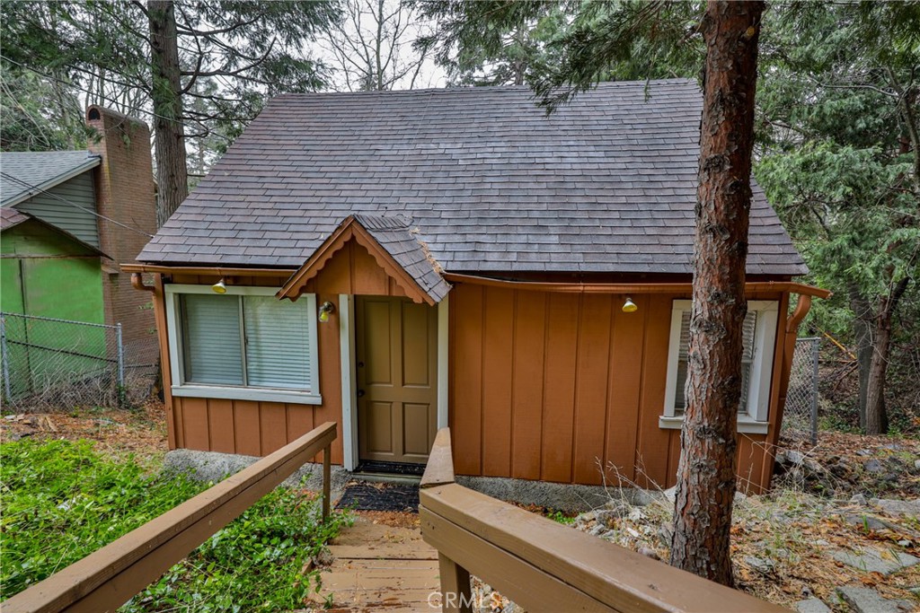 This charming and cozy mountain retreat has been well-loved! Featuring three distinct sleeping areas that also includes a loft, it offers plenty of space for relaxation. The inviting kitchen is conveniently located off the living room, where a wood-burning stove adds warmth and ambiance. The main level includes a ¾ bath, with an additional bathroom downstairs. Enjoy the convenience of two off-street parking spaces and a location close enough to walk to town while still feeling tucked away in peaceful seclusion. Step outside onto the quaint deck and take in the beauty of nature all around you! Summer heat won't be an issue with a central air conditioner to keep you cool.