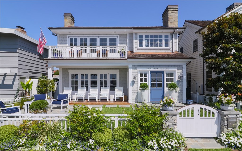 Classic Nantucket architecture with a West Coast vibe, this home brings the best of the Eastern Seaboard to Bayshores.
Rarely do you find a home with this location, style and detail. Completed in 2017, under the collaboration of Cynthia Childs AIA and Barclay Butera, this is the perfect setting to make memories . Coveted Bayshore Drive location offers sunny southwesterly exposures with glorious bay & sunset views of Newport Harbor.
Meticulously maintained gardens, a conversation fire pit & wood veranda greet you as you enter this timeless residence. A Dutch door entry, open floor plan with a California great room and live in kitchen, dining room; all generous living spaces with every modern comfort. 5 gracious en-suite bedrooms total, one on the entry level. A second level master suite boasts stunning bay views, master retreat with fireplace, luxurious bath, dual walk-in closets, French doors opening to a sunny deck. Other appointments include white oak wide plank floors, exquisite architectural detailing, refined stone finishes, 2 laundry areas, outdoor shower, security system, Sonos sound system , oversized 2.5 car garage, & so much more. Cherished moments created in this home will become narratives from generation to generation.