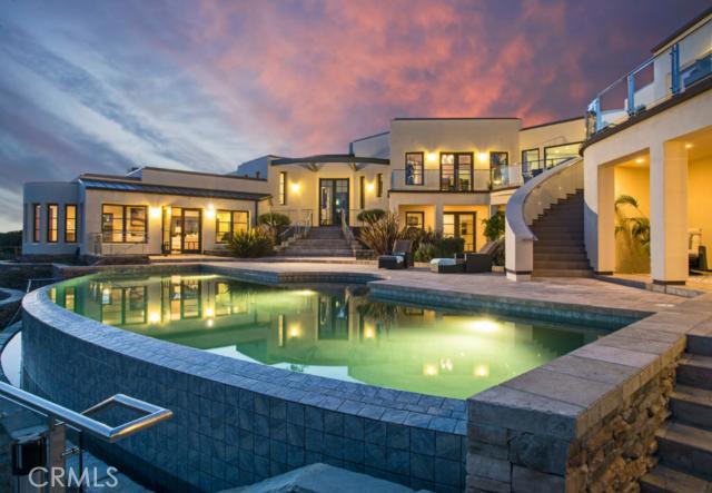 With more than 11 acres of private ocean view land, Villa Mar Vista is the largest estate offering in recent Laguna Beach history. A private drive leads you over a wooden bridge to this incomparable property, perched high above Tablerock Beach and Secret Cove in South Laguna and surrounded by natural preserved open space for the ultimate in privacy. A grand circular motor court welcomes you to the 11,000+ sf soft contemporary residence - newer construction and never lived in. Here, sleek expanses of stone meet the warmth of wood and walls of glass to bring the picture-perfect views into the spectacular interiors. Entertain in two living rooms - one with full bar - in the formal dining room, or throughout the grounds where expansive stone terraces, shaded loggias, an infinity edge pool, a private spa retreat, fire pit, and native landscaping create a setting reminiscent of an exclusive coastal resort. The five-star chef’s kitchen boasts a massive center island, two butler’s pantries, breakfast room. A dedicated bedroom level showcases a large-scale master suite with large dressing room and spa bath, as well as 3 hotel-style guest suites with private terraces and baths. Freestanding art/yoga studio, media room, two offices, garaging for up to 15 cars.