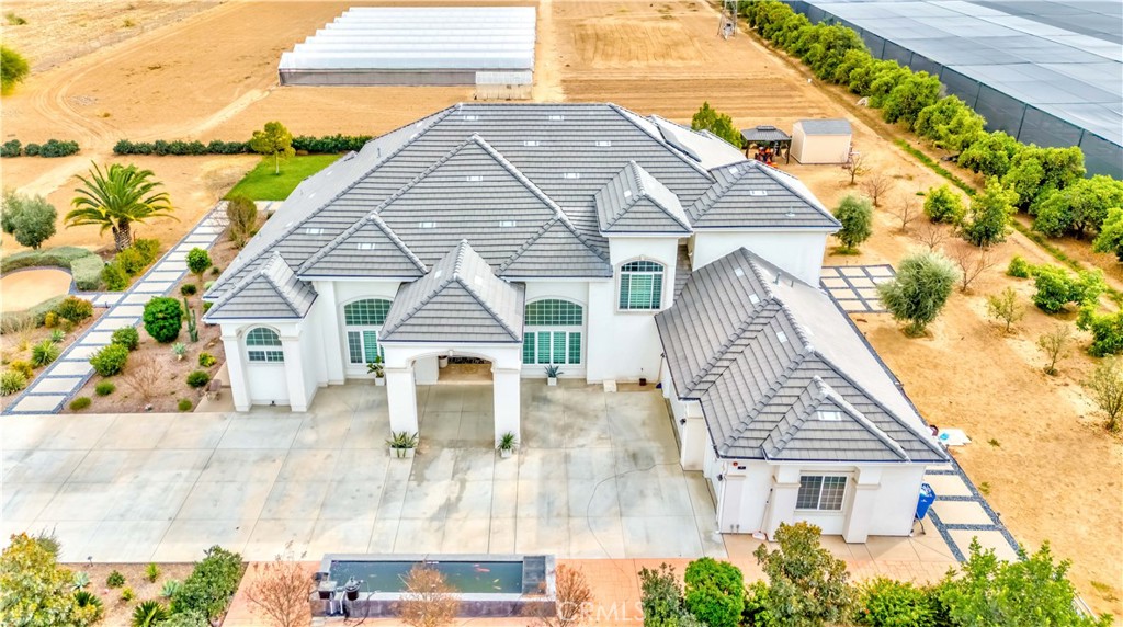 Wow! Huge price deduction. This exceptional custom-built home, nestled on a sprawling 5-acre lot, offers the perfect blend of luxury, privacy, and functionality. Located behind a gated front entry, this 5-bedroom, 6-bath estate features 6,500 square feet of living space, 3 bedrooms first floor including Master bedroom and 4 full bathroom, Office/bonus room could be another bedroom, 2nd floor you have huge bonus room and two bedrooms (you could use one of bedroom for second master bedroom) each bedrooms have own bathrooms and walk-in closet, providing ample room for both relaxation and entertainment. Built in 2015, the home is designed with impeccable craftsmanship and attention to detail.
You must see the green houses!
The grand formal living and dining areas boast soaring cathedral ceilings, creating a sense of openness and elegance. The chef’s kitchen is a culinary dream, featuring Quarts countertops for both kitchen and bathrooms, a large island, and top-of-the-line appliances. It seamlessly flows into a cozy breakfast nook and a spacious family room, ideal for both casual gatherings and formal occasions.
The luxurious master suite serves as a true retreat, complete with a walk-in closet and a spa-like private bath. Hardwood floors throughout the home add warmth and sophistication, while the thoughtful design ensures both comfort and style.
Outside, the property is a private oasis with 11 water stocks, a greenhouse, 40 mature orange trees, and 60 additional fruit trees, perfect for those who enjoy gardening or simply desire a serene natural environment. The 3-car garage provides ample parking, while the expansive lot allows for plenty of additional space. Whether you’re looking to entertain or unwind, this home offers unparalleled luxury and privacy in a beautiful setting.
Two set of solar , Koi pond .... 8 huge green houses..... two private decks from bedrooms..... too many things to mention
