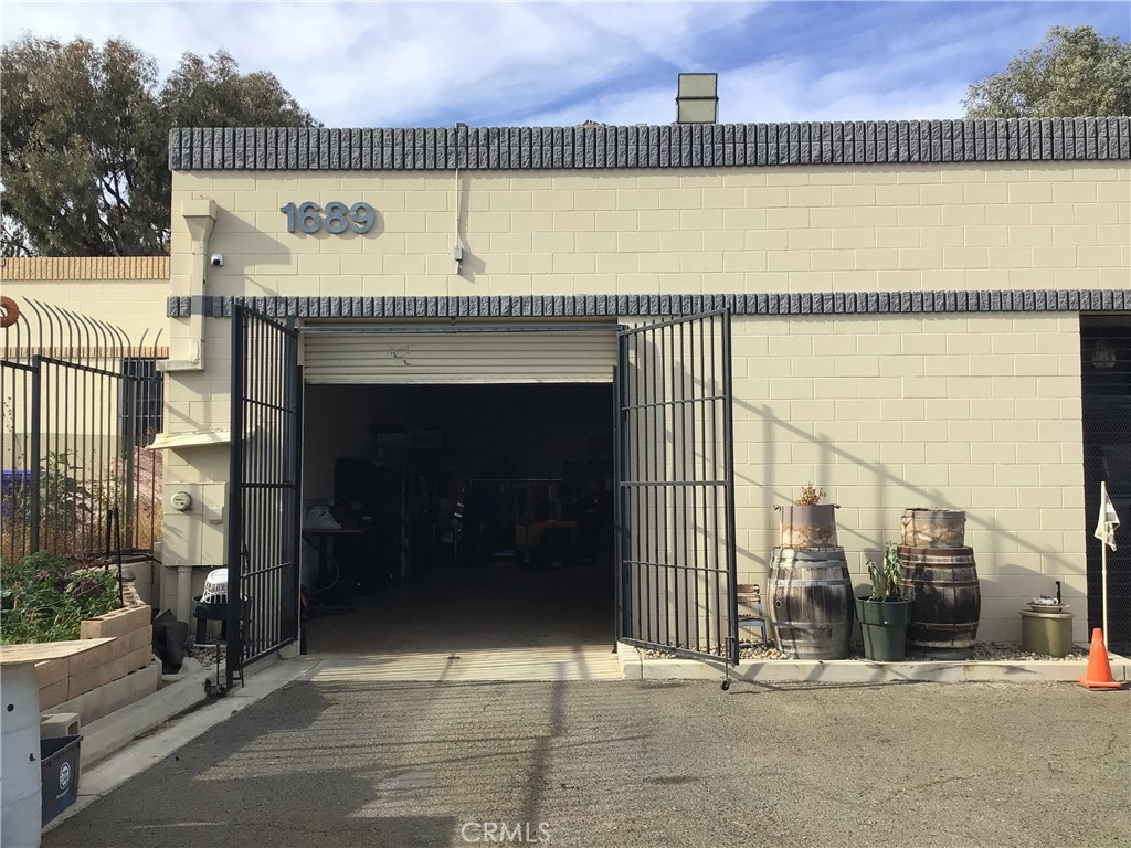 Convenient located close to the 60, 91 and the 215 Freeway. This free-standing building is the corner unit as you enter "The Production Business Park", Can be use as either warehouse or for light industries. Within these 3,104 sq. ft. building there is an office area, one rest room, two 10 x 10 commercial roll-up doors, a separate entrance to the office area. The ceiling is 13' high with 200 AMP / 3 phase power, Secure electric fence around the front and the two sides. Power wash station area inside the gate. Parking spaces inside the gate for staffs and visitors. A must see.