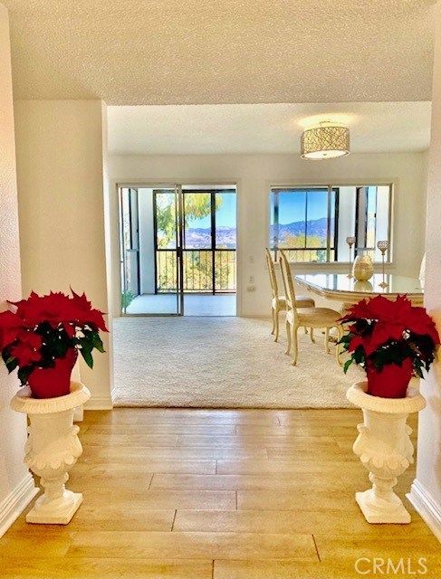 OVER $60,000 PRICE REDUCTION!! This is the home you've been waiting for! Stunning 180-degree views of city lights, mountains and trees with breathtaking golden sunsets from almost every room. This rare Casa Dorado is located in a Private, serene and peaceful location and has an added sunroom with windows all around it to maximize your enjoyment of the view. Kitchen has granite counter and stainless-steel appliances including microwave, stove, dishwasher and refrigerator. Extra built-ins too. One of the most popular floor plans with spacious and open living room and dining room with bedrooms on opposite sides with updated baths for each. 24 hour view to enjoy your own cheerful personal oasis. Laguna Woods Village residents enjoy their own private 27-hole golf course plus an exclusive 9-hole par 3 golf course, 5 swimming pools, 7 clubhouses, over 250 social organizations, equestrian center, 3 fitness centers and much more.