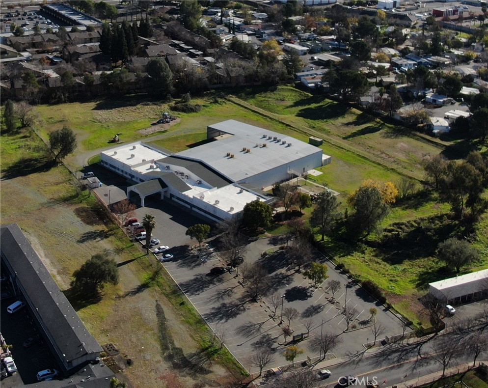 World Class Flex Building owned and operated by the Feather River Recreation and Parks District in beautiful Oroville, CA. Total of 39,700 sq. ft. built in 2000 on 4.93 acres. Currently used as the district headquarters and includes a huge gymnastics facility, dance studios, martial arts studio, rock climbing room and various offices and educational & daycare facilities and outdoor play areas.
At nearly 5 acres, the subject property offers plenty of expansion opportunities for additional added value. Additional improvements could include indoor or outdoor pool, office space or additional health and recreational facilities. Perfect for government use, schools, fitness clubs, nonprofits and office use. The Subject Property is zoned Corridor Mixed Use (MXC) and allows for general commercial uses including retail, shopping center, storage and even vehicle sales. Perfect opportunity for an investor to redevelop into a profitable income asset.