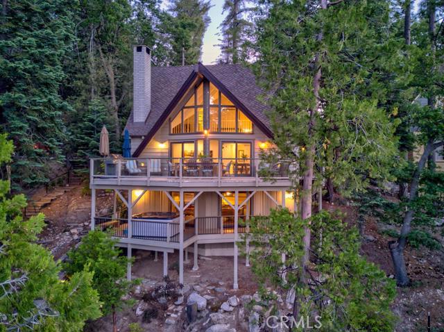Looking for the perfect getaway? This highly sought after Lakefront Prow has it all! Expansive lake views, single slip dock w/ party deck. Walking distance to Lake Arrowhead Village,Blue Jay & Lone Pine Island. Tastefully renovated w/ designer touches throughout. The main floor features an open concept kitchen, dining/living rm w/ vaulted ceiling's & fireplace, large entertainment deck, master bedroom & bath. Upstairs you'll find two en-suite bedrooms. Lower level has a laundry rm, storage rm, bathrm, game rm/family rm w/ pool table, fireplace & deck w/ hot tub. This property has plenty of parking & has been a successful vacation rental. Don't let this rare opportunity pass you by!