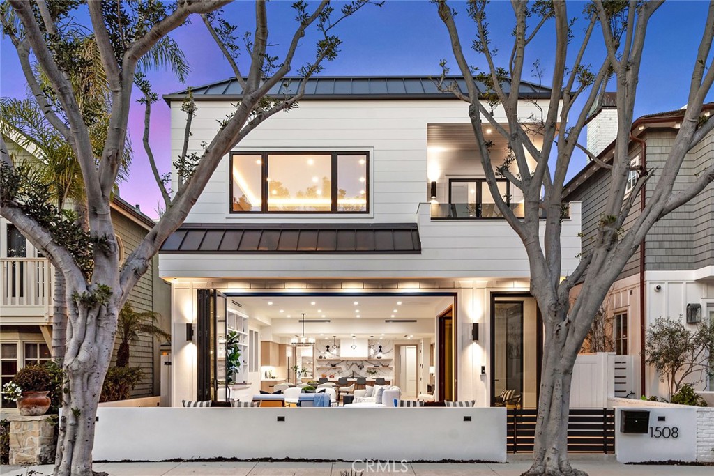 This stunning, newly-constructed, custom home embodies the epitome of the Newport Beach lifestyle, where lazy days are spent soaking up the sun with warm sand and pounding surf just steps away as passionate surfers navigate The Wedge or experiencing ocean sunsets and city lights from your private roof top deck. Whether you're a passionate surfer, or simply someone who appreciates the finer things in life, this property offers the indescribable experience of living beachside. Step into this stunning 3,789 s.f. +/- home, with 5 bedrooms & 5.5 bathrooms, and be transported to a world of next-level comfort and style. Salt air breezes flow into an open living room with 11’ ceilings, with La Cantina bi-fold doors linking to an outdoor living space with a fire pit, and a private patio with water feature. Custom home audio creates the soundtrack for a social space, and luxe touches include wide-plank European oak floors, custom cabinets, and a Control 4 System that manages everything from lights to AC. Dramatic stone surfaces create a striking kitchen, and a waterfall quartz-topped island is a place to unwind with a premium vintage from the 106-bottle temperature controlled wine room. Thermador appliances include a 6-burner range with grill & dual ovens, a wine chiller, and a paneled refrigerator. The main floor is completed by a guest powder room, elevator, and mudroom linked to the 2-car garage & carport. The second floor is a blissful retreat, where three gorgeous guest rooms feature ensuite baths appointed with on-trend custom tile, and laundry room. A stunning master bedroom is accentuated with a wood slat wall, 11’ backlit tray ceiling, and a walk-in closet with glass doors that are just waiting to showcase luxury labels. The impressive ensuite is indulgent, with a steam shower, soaking tub, and high-end stone surfaces. The 3rd floor has the feel of a luxury treehouse, with a full bathroom creating the option for a 5th bedroom. A wet bar with a wine cooler and refrigerator makes entertaining a breeze, while two private decks offer panoramic views that stretch across city lights and bays that drift out to the ocean. Step out to the BBQ kitchen and grill while the sun sets or cozy up next to the outdoor fireplace. Additional features include solar panels, a car-charger-ready garage, outdoor shower, and a location that offers a wide alley for an easy trip to spectacular dining & shopping on the Balboa Peninsula, Balboa Island, and greater Newport Beach.