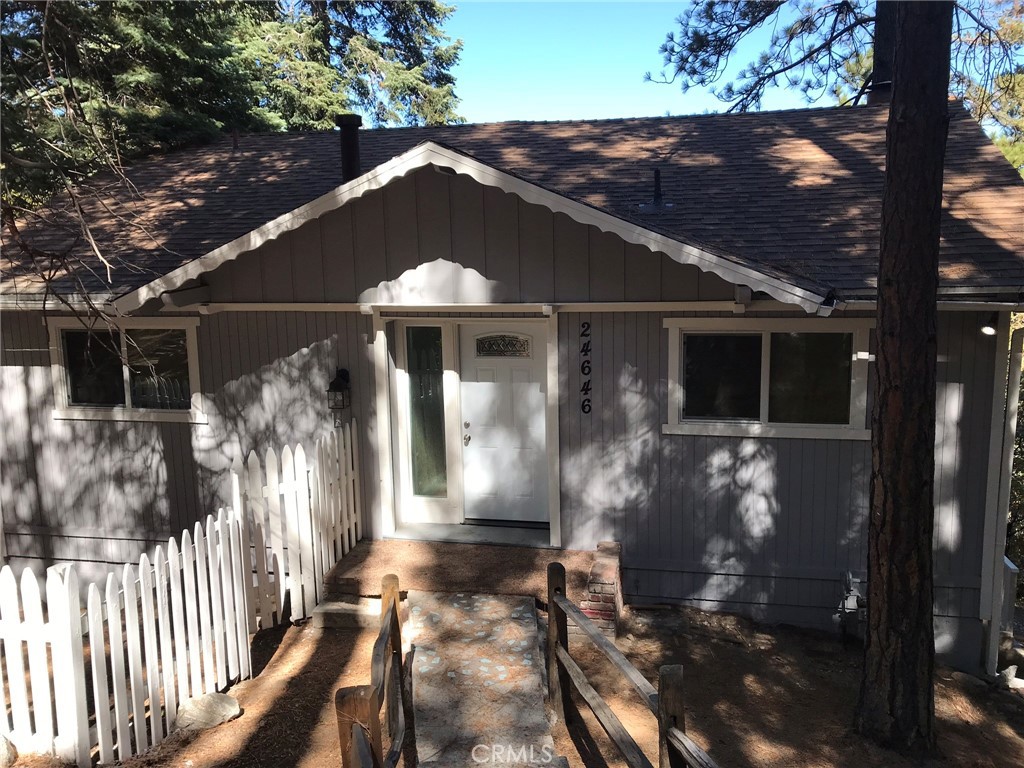 This charming four-bedroom house in Crestline, California, offers a perfect blend of modern comfort and rustic appeal. Tucked away in the serene San Bernardino Mountains, the property boasts stunning views and a peaceful atmosphere. Inside, the spacious open-concept living area features large windows that fill the space with natural light and showcase the picturesque surroundings. The cozy fireplace adds warmth and character, making it an inviting spot for family gatherings. The fully equipped kitchen includes modern appliances, ample counter space, and a dining area that opens onto a private deck, ideal for outdoor entertaining. The primary suite is a tranquil retreat with an en-suite bathroom and generous closet space. Each additional bedroom is well-sized, offering flexibility for family, guests, or a home office. The additional bathrooms are thoughtfully designed, enhancing convenience for residents and visitors alike. Outside, the property is surrounded by lush trees and offers ample outdoor space for relaxation or play. A driveway provides convenient parking and easy access to nearby hiking trails, Lake Gregory, and local shops. This home in Crestline is not just a house; it’s a perfect mountain escape that harmonizes comfort and nature, making it an ideal choice for those seeking a peaceful lifestyle. **ALSO AVAILABLE FOR LEASE**