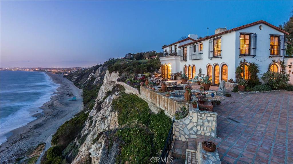In 1925, renowned landscape architect, Frederick Law Olmsted, Jr. was given his choice of any site in Palos Verdes Estates in gratitude for planning the new city. He selected this spectacular, 65,000 square foot bluff top parcel, with approximately 270 feet of ocean “frontage” overlooking the Pacific ocean, coastline and Santa Monica Bay. Acclaimed architect, Myron Hunt was selected to design the magnificent, Spanish inspired estate. Hidden by a grove of eucalyptus trees, and perched high atop the sea, "Casa Felicia” features thick plaster walls, old world charm and lush landscaping throughout. The sprawling grounds include a serpentine driveway, made from oversized, Mexican bricks, which leads to a striking fountain and dramatic entry. Along the bluff, the expansive patio provides a stage to the amazing vistas. The driveway is flanked by “the coliseum”, a tremendous expanse of lawn and stone walls, which has been the site for family weddings as well as many other celebrations. Available for the first time in over 50 years, this majestic estate is a once in a lifetime opportunity. If privacy is the ultimate luxury, then this is a treasure. Come claim it as your own.