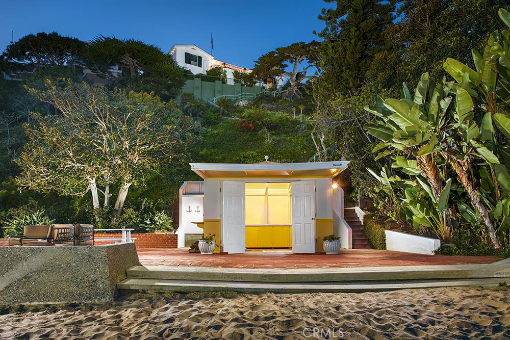 This oceanfront estate parcel is on the sand in the esteemed private community of Emerald Bay. Held in the same family since 1932, ‘EL PARADOR’ presents a rare opportunity to buy the “best of the best” as the original owner had her choice of most any position on this scenic cove. The current offering was assembled in a recent merger of the original lot #156 with a substantial portion of the former lot #120, creating the newly expanded parcel #156; now the single largest on the oceanfront in all of Emerald Bay. It features a private beach area with almost 70’ of frontage at the quiet western end of the cove, as well as a sand-front cabana and large entertaining terrace. The existing, 1930’s California colonial style home serves as a comfortable beach getaway. Alternatively, one could build new and create a home of 13,000 square feet or larger, with an oceanfront swimming pool, and direct walk-out-on-the-sand access from a beachfront cabana and terrace. The gently sloping topography will allow for an exceptionally livable new plan with all floors taking in ocean views. Street to street access allows for an oversized multi-car subterranean garage. The cove, coastline, ocean and nightlight views are beyond compare, as is this irreplaceable opportunity.
