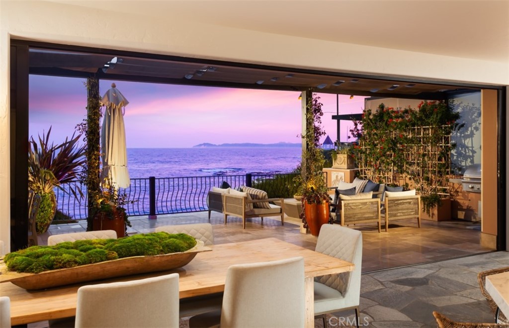 Recently remodeled and sitting right on the sand in Fisherman’s Cove, 675 Cliff Drive is a rare light Tuscan-style oceanfront property. Offering the very best of beachside living, you will find waves washing ashore, world-class dining, incredible art galleries and shopping. The spacious & meticulously-maintained property boasts multiple levels, five bedrooms, four and a half baths, open living spaces including a separated cabana-style studio. The studio is complete with a bath, kitchenette, and a serene outdoor patio. The expansive master suite sets an unparalleled standard of luxury living, with its spa-like bath, spacious walk-in closet, and picturesque ocean views through large windows provide an abundance of natural light and breathtaking sunset views. The main level features spacious open living areas, 10 foot ceiling's, a remodeled kitchen, and views through wall to wall sliding pocket doors. Beyond the doors you’ll find a large deck overlooking the sand and miles of Pacific Ocean. The lower level of the home has a complete bar area, separate wine cellar, fireplace, family room, and private balcony overlooking the ocean. Additional amenities include separate utility and laundry room, two-car garage, & ample space for storage and parking. Embrace the ultimate indoor-outdoor coastal lifestyle in this oceanfront masterpiece, while enjoying a location that continues to rank as one of Orange County’s most desirable places to live.