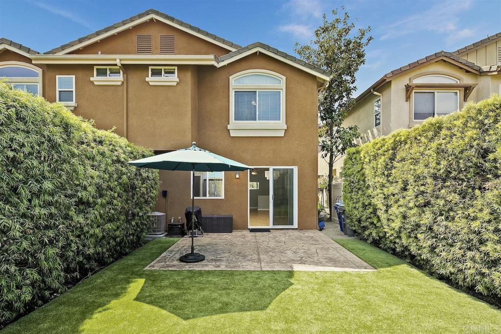 What a gem of a home with large private professionally landscaped backyard boasting synthetic turf and entertaining patio. As you enter the home you are immediately greeted into a light and bright living/dining area with windows all around. The bright white kitchen with Stainless steel appliances and walk-in pantry looks out to the beautiful back yard. Gather around the island while enjoying the gentle breezes from the open sliding doors to the backyard. Upstairs there are two spacious bedrooms with two bathrooms. The primary en-suite bedroom enjoys lovely easterly views. The attached garage with door connecting from the home has epoxy flooring and laundry along with one assigned parking space. One of the best locations within the Canterra complex, this home is tucked away from the street and towards the very back corner of the complex. The community features a large pool and playground which are a stroll away from this home. Freeway close, with shopping, dining, and groceries nearby while being in one of the best areas of San Diego.