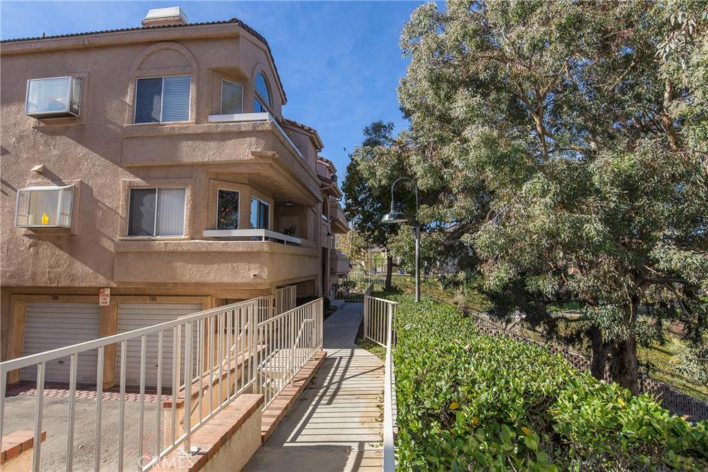 Why rent when you can own? This immaculate condo is light and bright with views of the hillsides and breathtaking sunset. 3 spacious bedrooms plus an expansive LOFT make this home perfect for families, college students or work-at-home professionals! The vaulted ceilings, bright skylights, wrap around balcony, fireplace and garden window make his home a true oasis. The over-sized 2 car garage, upstairs indoor laundry and the privacy of no neighbors above make this home a place you will want to call your own for years to come! This community is not only gated but is also just moments from the 14 freeway, Golden Valley Road, excellent shopping and restaurants! This unit is located at the back of the community which allows for the private and quaint setting! Low HOA and no Mello Roos! Schedule a showing today! You will be so glad you did!