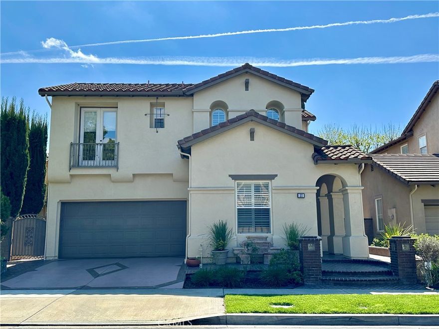 Located in the prestigious gated community of Northpark in Irvine, this stunning home welcomes you with a brick-paved pathway leading to a grand front porch framed by elegant archways. Inside, travertine floors and graceful archways create an effortless flow throughout. The bright and airy living room is filled with natural light, while the formal dining room features a French door opening to the side yard, perfect for alfresco dining. The inviting family room offers a built-in entertainment center and cozy gas fireplace, seamlessly connecting to the chef’s kitchen. Golden honey wood cabinetry, granite countertops, a double oven, five-burner gas stove, and a walk-in pantry provide both style and function. A breakfast bar and casual dining area open to the beautifully landscaped backyard. Designed for relaxation and entertainment, the backyard features a brick-paved patio, lush greenery, a tranquil water feature, and a spacious pergola with ceiling fans. A built-in BBQ completes this outdoor retreat. Upstairs, a versatile loft offers additional space for work or play. The luxurious primary suite features a generous walk-in closet and an en-suite bath with dual vanities, a jacuzzi-style tub, and a walk-in shower. Two secondary bedrooms, one with a private balcony, share a dual-sink bathroom. Conveniently located near Hick Canyon Park, award-winning schools, shopping, and dining, this exceptional home blends elegance, comfort, and prime location.