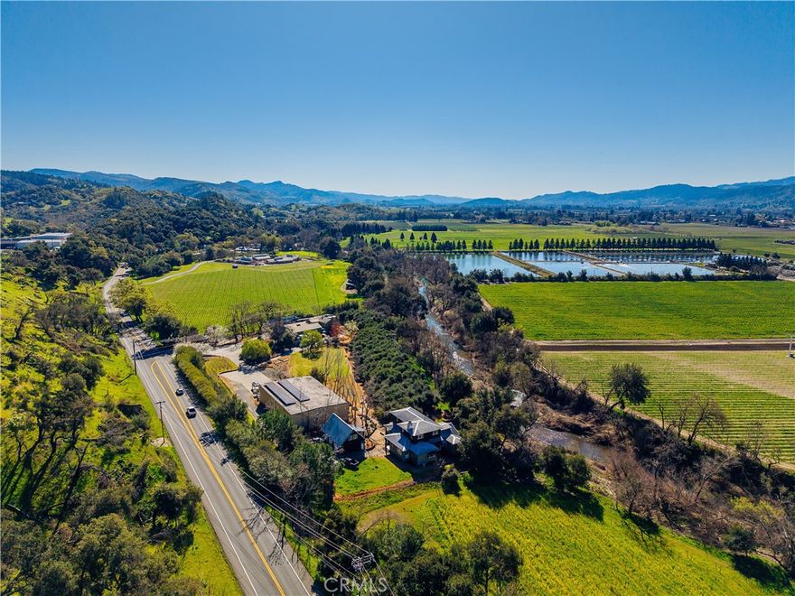 Welcome to Napa Valley’s most serene and prestigious winery estate, where heritage, luxury, and unparalleled winemaking potential converge in the heart of St. Helena. This historic, fully operational winery spans 5.67 +/- acres along Silverado Trail, between Meadowood Resort and Auberge du Soleil, offering immediate revenue potential with extraordinary expansion opportunities, ideal for winemakers, entrepreneurs, or hospitality visionaries.
The 5,500 +/- sq. ft. production facility features 6,200 +/- sq. ft. of crush pad space, 82,000 gallons of tank storage, and a 6,000 +/- sq. ft. warehouse with a permit to double in size. Permitted for 40,000 gallons annually, with a waste-water upgrade to reach 100,000 gallons, this turnkey, high-capacity facility is perfect for estate winemaking and custom crush clientele. Solar electric power ensures sustainability. The newly remodeled tasting room, within a charming guesthouse, is ideal for private tastings, luxury lodging, or events. A bocce court and expansive deck showcase panoramic views of vineyards, rolling canyons, and the tranquil Napa River, creating an unmatched, peaceful retreat. Highly coveted hospitality entitlements allow daily tastings for up to 48 guests, plus 69 exclusive marketing events per year, maximizing brand visibility and revenue streams. The 3,518 +/- sq. ft. Craftsman-style home with an additional studio is perfect for guest accommodations, short-term rentals, or VIP stays. A lawn and olive grove along with numerous gardens and fruit trees, enhance the estate’s beauty and provide an idyllic setting for exclusive wine releases, private gatherings, and weddings. The estate includes ample parking for 35+ vehicles. With immediate income streams, high-production potential, and premier hospitality offerings, this custom crush facility and full-production winery is a rare Napa Valley residential and commercial opportunity.