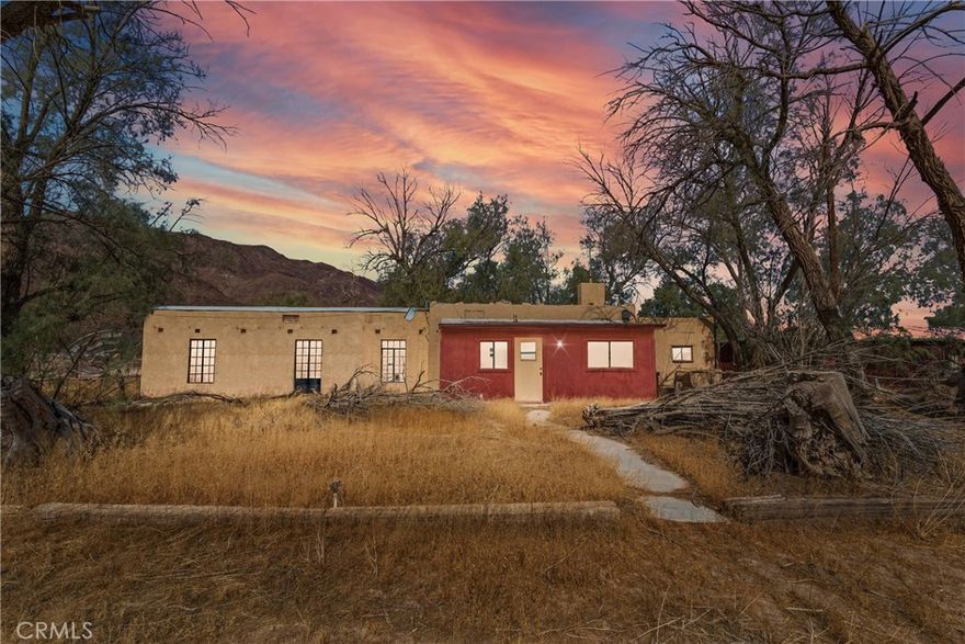 Start your own ranch by the Newberry Mountains as golden eagles soar overhead. This ranch property sits on 10 acres, located off a secure private road with it's own well. Built in 1940, the 1,166 SqFt home features classic architectural cues from the early days of desert living including thick wooden doors, iron-accented windows, a centerpiece brick-inlaid wood-burning stove and vintage appliances. If you know anything about ranches, you know it ain't all about the living quarters. There is over 5,000 SqFt of outbuildings on this property, including garages, workshops, washrooms, vehicle storage, a tack room, large cinder block garage and more! Horses are already welcome with two shelters on site and more. There is a pond behind the home made of volcanic red rock, perfect for ducks, chickens or even koi fish. A retro concrete swimming pool with waterslide and deck is included in the sale. This is the perfect starter ranch, or the ideal site for an off-road enthusiast looking to build a motocross track and have easy access to the open desert for their sand toys. This property has an amazing view of the Newberry Mountains, home to a large population of desert bighorn sheep. The full 10 acres is a combo of two parcels, APN 0528-081-61 and 0528-081-62.