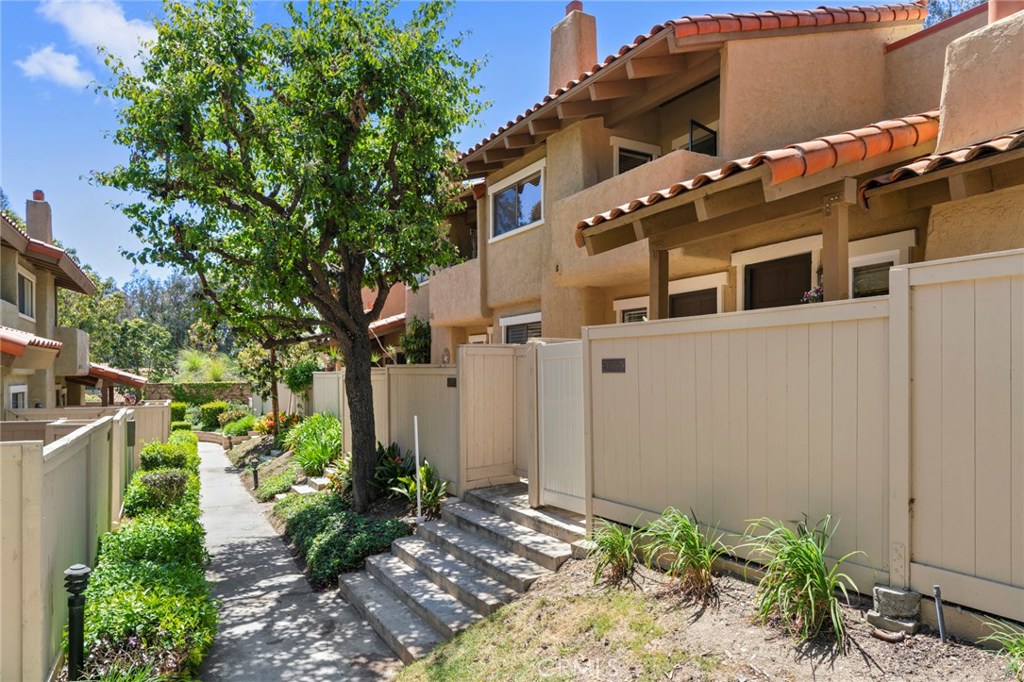 Westbluff Village is located on the West Side of Costa Mesa adjacent to parks, nature preserves, miles of trails, Goat Hill BMX park and just over a mile to the beach, this location is hard to beat. The 1300 sq ft seem much bigger as you enter the home through an enclosed private patio, the living room has soaring wood beamed ceilings, east facing windows for lots of daylight and a gas fireplace. The dining area is situated between the living room, kitchen and the atrium where you can have your own herb garden or enjoy your morning coffee. The kitchen is convenient with ample counter space and cabinets, there is half bath down and an attached two car garage with laundry. Upstairs are three over sized bedrooms, the two in the rear of the home have walk in closets and share a full bath. The master bedroom has vaulted ceilings, a private balcony and walk in closet. The bath consists of a large vanity and walk in shower. Improvements include new paint, new carpet, LED lighting and wood floors through the main floor. The community has a sparkling pool, spa and a clubhouse, plus a private gate to the parks. This home has a clean pallet and is just waiting for your own decorator touches throughout.