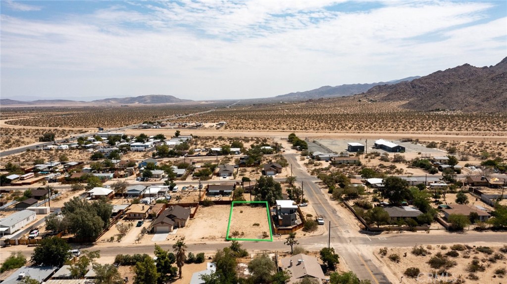 Heart of The Village. Walk to the Joshua Tree Saloon, Farmers Market and local dining. Walking distance to the Coyote Hole nature hike. Utilities, electric and water, are available. New construction nearby. Paved roads. Great location! (Street number is approximate and not assigned by County; therefore, please use APN number to navigate to property.) APN: 0603-142-17