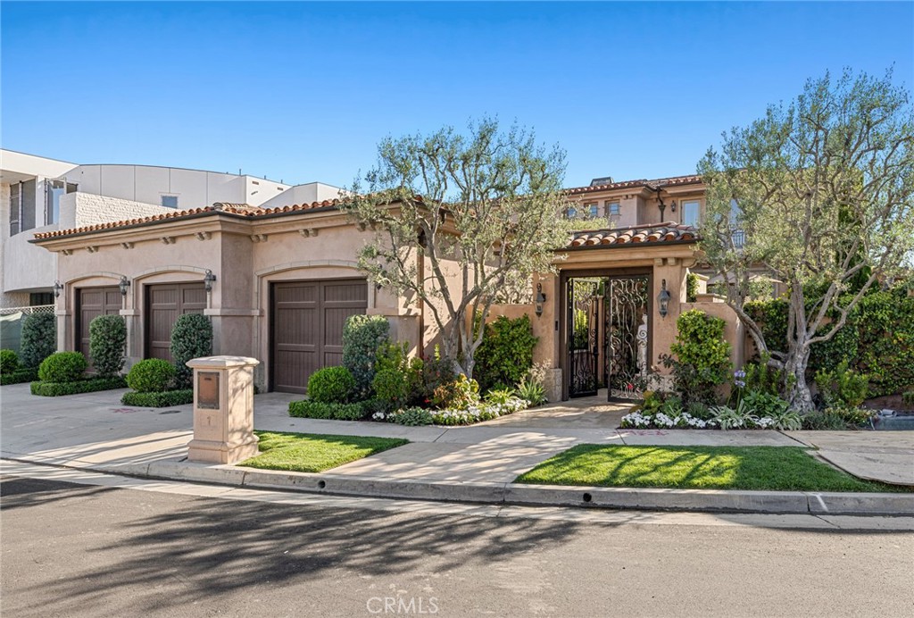 From the shimmering Pacific Ocean and the waters of Newport Harbor to city lights, Catalina Island, magical sunsets and the gleaming towers of Fashion Island, views from the top of Spyglass Hill in Corona del Mar are unmatched, and this luxurious home takes full advantage of them. Nestled on a quiet cul-de-sac, the custom residence is influenced by its stunning views day and night, during parties, special times with loved ones, or simply kicking back on a carefree day. Privacy is also unsurpassed, with entry gates leading to a front courtyard that offers a superb setting for soirees and spur-of-the-moment get-togethers with the special people in your life. A custom glass and wrought-iron entry door opens to a dramatic double-height foyer with a sweeping staircase. Formal occasions are graciously accommodated by a grand dining room with a fireplace and two sets of French doors that open to the courtyard for easy indoor/outdoor living. Phenomenal views enrich a living room with mitered corner windows, a fireplace and access to the backyard, where an in-ground spa invites view-embellished relaxation. A separate ocean-view family room also opens to the backyard and hosts a walk-in wet bar, a fireplace and a built-in entertainment center for memorable movie-nights. Approximately 5,419 square feet, the impressive home features an office with built-ins, a wine cellar, and a dine-in chef’s kitchen with island, two sinks, Thermador double wall oven, Sub-Zero built-in refrigerator, Viking six-burner cooktop and two Miele dishwashers. Four ensuite bedrooms and four full and two half baths include a main-level suite, and a lavish second-floor primary suite with outstanding ocean views, a fireplace, walk-in closet, ocean-view tub and large shower. A versatile primary suite sitting area boasts a dumbwaiter to the kitchen, fireplace, wet bar, and incredible ocean and city-light views. An elevator, three-car garage and manicured grounds are also featured. Spyglass Hill is close to award-winning schools, Fashion Island shopping, Corona del Mar’s restaurants, beaches, golf courses, and the scenic hiking trails of Buck Gully Reserve. Take advantage of this rare opportunity to beautifully elevate your lifestyle to lofty new heights.