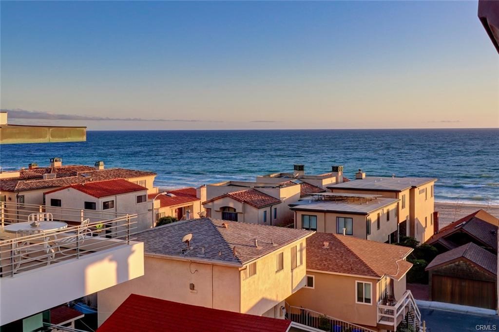 Do you get the feeling that most of the new construction homes being built all come from the same "cookie cutter" design? The same floor plan, the same colors, and same elevation? Well not anymore. This new construction property will be the standard for all 30x90 North/South walk-street homes. Boasting protected ocean & mountain views with no power lines in sight, this home has it all for the most discerning buyers. Amenities include: Master suite features limestone fireplace & retracting glass doors with seamless glass railings boasting ocean views to Malibu. Master bath has floating vanities with LED strip lighting, travertine countertops, & big walk-in closet. Vaulted ceilings with wooden beams complement built-in cabinetry & baseboards throughout the home. Oversize dining room with space for 14 people, massive quartzite island that seats 6 with views of MB Pier. Kitchen has custom cabinetry & a retracting glass wall separates the kitchen and covered outdoor living space for dining al fresco. Outdoor living space features a gas fireplace, wall mount television, grill & built-in ceiling heaters by Infratech. Appliances include refrigerated drawers, Thermador refrigerator & stove. Spacious media room with wet bar & sliding glass doors that open up to large front yard patio, which is perfect for entertaining guests & enjoying the sunset. 3-stop elevator, Nest Thermostat, Lutron Lighting system, & IPad control panels. Video tour https://www.youtube.com/watch?v=lEjBWKPtxsY