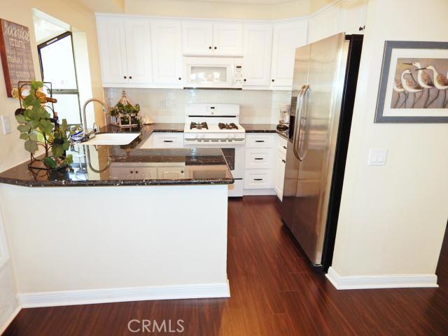 You’ll Love this Completely Updated Condo in the Highly Sought After Gated Community of Harbour Pointe. Open Floor Plan with Gas Burning Fireplace, Beautiful flooring throughout, Granite Counters in Kitchen & Bathrooms and Two Spacious Bedrooms. The Bathrooms are Split – They Share an Area that has a Tub Shower Combo. One Bath Area has Vanity with Two Sinks and Other Bath Area has Vanity with One Sink. There’s 2 Patios and One Even Has a Grassy Area. This Unit Comes with One Parking Spot and a One Car Garage. Approximately One Mile to the Beach and Walking Distance to Shopping. Enjoy the Community Pool, Spa and Recreation Room.