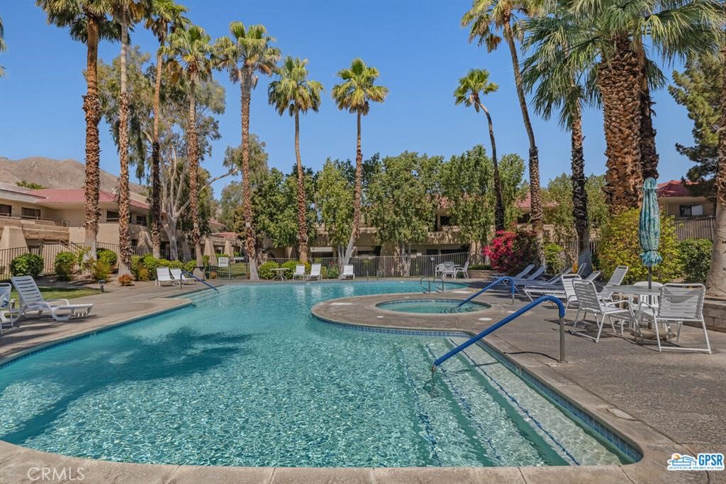 Bring your toothbrush, swimsuit and towel, and enjoy your new lifestyle in the Palm Springs Villas II community! This beautifully turnkey condo offers many desirable upgrades including custom paint, newer AC unit, smooth ceilings (popcorn removed), and crown molding. The home features stylish window cabinets in the kitchen with a new refrigerator, newer queen bed, an updated bathroom and tile flooring throughout. It is in a perfect location: quiet and right across from a greenbelt area. The resort-like community offers tennis courts, six sparkling pools and spas, barbeques and nicely landscaped lawn areas. Just minutes to restaurants, boutique shops, and many Palm Springs area attractions. Palm Springs Villas II is on Fee Simple land that you own; no land lease payments to make. Perfect and move-in ready for a full or part-time residence, an investment property, or a wonderful vacation getaway. Don't miss this gem!
