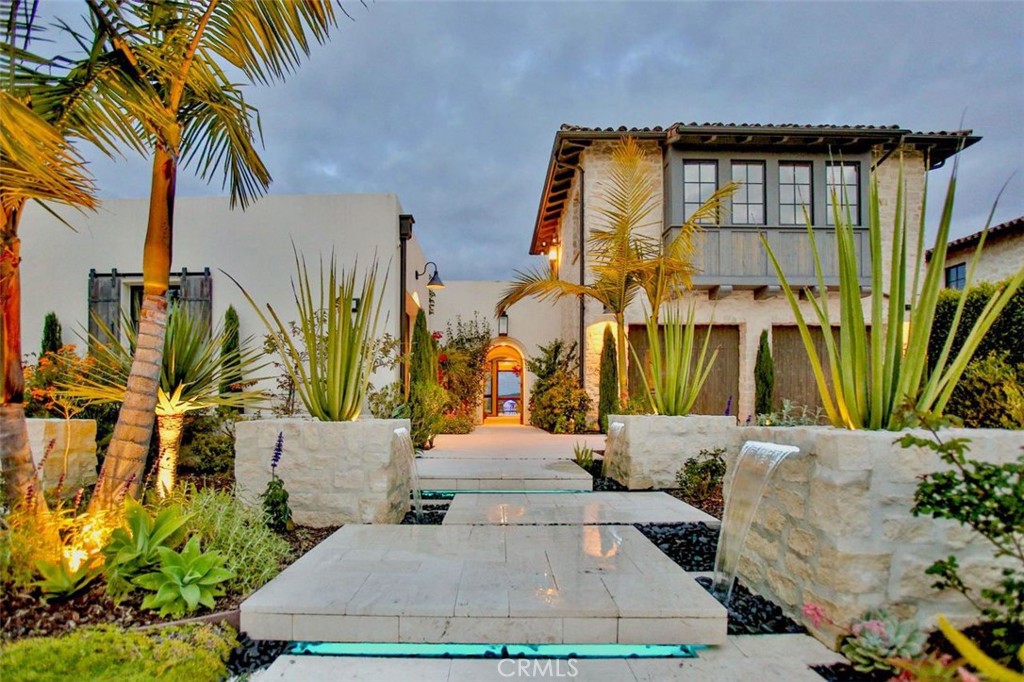 + Completely Unobstructed Panoramic Views of the Rolling Hills and Canyons of the Crystal Cove State Park Wilderness (no roofs, no trees, lowered fence). Sunrise Views. Peek-a-boo Ocean View
+ One of Largest Lots with Single-Level Luxury Home in Coral Canyon of Legendary Crystal Cove
+ Serene Backyard Landscaping with Rain Curtain Fountain, Fire on Water Feature, Crystal Sphere Fountain flowing into the pool. Plus a Curved Water Fountain in the Front Yard, and Grand Entrance Water Pilasters with Floating Steps welcoming to the Resort-style Living
+ Large Designer, Heated Salt Water Swimming Pool with Spa and Baja step
+ Open-Concept Design with Stunning Beamed Ceiling, and High ceilings throughout the house
+ Top of the line French Limestone throughout the house
+ One slab Taj Mahal quartzite countertops throughout the house, outdoor kitchen, and fireplace
+ 3 Completely Retractable Glass Walls to the Backyard
+ Brand new outdoor kitchen appliances with Designer Pizza Oven
+ Whole House Water Filtration System for the true Spa experience
+ Video Security System
+ Built- In Home Vacuum System
+ Smart Home Automaton
+ Backyard Landscape was redesigned in 2023 with beautiful white limestone inspired by Mediterranean style of Ibiza, Spain
+ Sizeable detached casita above the garage is to ensure privacy for guests or extended family
+ Mesmerizing blend of succulent and sage plants that shape a charming, elegant curvature
+ The house is facing Rising Sun for the pristine moments of complete serenity and balance. The ancient fire-water astronomy inspired design aligns the swimming pool, Crystal sphere water fountain, and the grand entrance floating steps together with the East-West 33N latitude. Looking from the top, the Frontyard design represents the ancient Jupiter symbol of expansion, prosperity, and wealth. The majestic sphere water fountain is guaranteed to impress you and your guests, day or night, with an awe-inspiring light spectacle! The accordion retractable glass doors blur the boundary between indoors and outdoors, offering continuous living space. As a resident of Crystal Cove, you'll have direct access to top-notch shopping, dining, Historic Crystal Cove Beach, and elite schools. The community amenities include a large lap pool, hot spa, gym, tennis and basketball courts, and trails for hiking and biking. This remarkable retreat-like property is maintained organically, free of chemicals, making it an absolute MUST-SEE Gem.