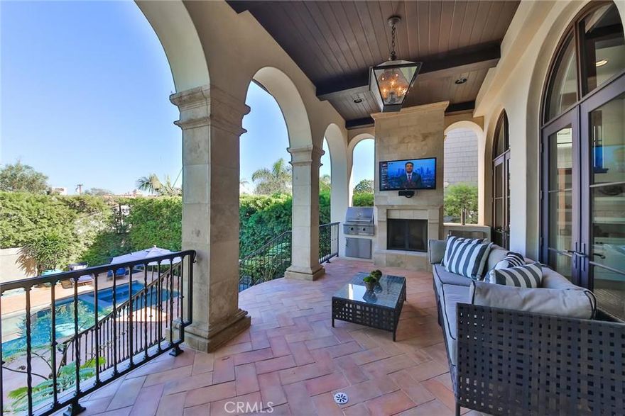 This is an entertainer’s dream home.  This amazing Montecito Style Home is situated in the heart of the Manhattan Beach Hill Section.  Designed by Louis Tomaro and built in 2007, the property has gone through an extensive remodel that was just completed in November 2015.  This city view home features 5 bedroom, 5.5 baths in 5151 sq ft (per last appraisal) with a 3-car garage sitting on a 7200 sq. ft. lot.  The entrance is grand…a mixture of new and mature landscaping, gated entry and Walker Zanger tiles.  You enter into an elegant foyer with high wood beam ceilings, finished walnut floors and a light and bright open floor plan.  Custom gourmet kitchen with Calcutta, Limestone, Ann Sacks tiles and Walnut Butcher compliment the top of the line appliances. Open living space that opens up to outside entertainment Logia w/fireplace, pool, spa and sport court.  Incredible Master Bedroom and Bath with fireplace, private balcony and views of the mountains and city lights.  Downstairs basement has an Entertainment Great Room w/windows for natural light, a fitness gym, Au Pair or guest bedroom, separate bath, 500 bottle refrigerated wine cellar and Media Center. Top of the line Audio/Visual and Entertainment system throughout the property.