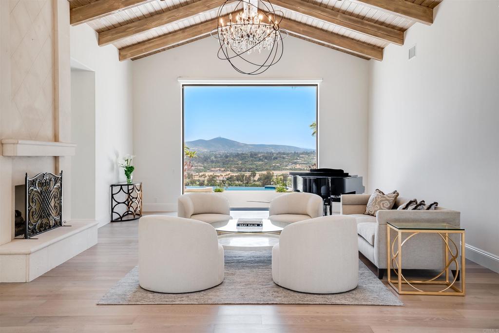 Expansive panoramic valley views complement this spectacular estate fresh off a 2023 remodel. Ideally located in the southwest corner of Rancho Santa Fe’s Covenant this step free custom single level smart home offers turnkey living in an extraordinary setting. The property features five generous bedroom suites, each offering a private oasis for relaxation. The primary bedroom is a true sanctuary, complete with a lavish en-suite bathroom highlighted by indoor and outdoor showers and a private patio offering breathtaking views of the surrounding landscape. The gourmet kitchen is a culinary enthusiast's dream come true and the temperature controlled glass wine cellar turns your collection into art. An executive office offers an ideal space to work from home and the detached guest house presents a wonderful venue to host family and friends. Come and see what life on top is all about.