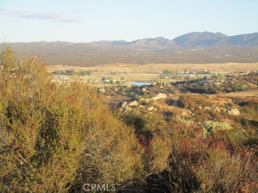 This private lot at the end of a cul-de-sac features lake and mountain VIEWS and several boulder outcroppings. At least half of the parcel has a gentle slope, with a steeper slope towards the back. Owner may carry with at least $10,000 down. Just a 20 minute scenic drive from Temecula, Lake Riverside Estates is a unique equestrian community that offers a pool and playground with picnic area, private airstrip, fire department, equestrian arena, many miles of riding trails, and a 55 acre lake with dock for fishing, kayaking, or just peaceful enjoyment.