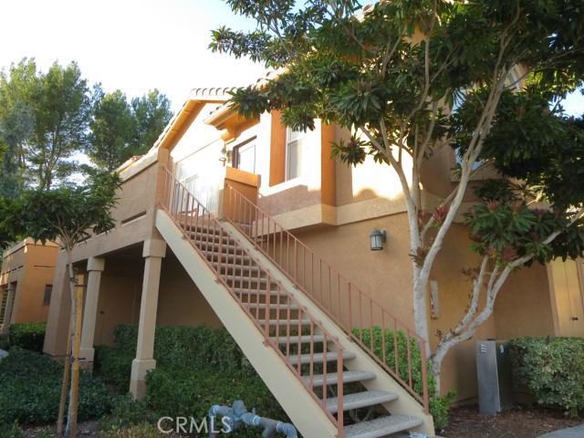 Great location and end unit in Tuscany. Carriage style unit with no one above or below. 2BR/2BA. Open floor plan with vaulted ceilings in living room & bedrooms. Lots of natural light. Custom baseboards, neutral carpet, and warm neutral paint. The kitchen has white cabinetry and stainless steel appliances (refrigerator included.) Oversized bedrooms with mirrored wardrobes. Master bath has double sink vanity & oval soaking tub/shower. Living room has a cozy gas fireplace and large window overlooking a spacious deck with a laundry closet for full size washer and dryer (included). The dining area has a bay window, storage closet with mirrored wardrobe door, & decorator lighting. Plus a one car garage. Tuscany is rich in amenties. Enjoy two resort style pools with large deck areas & spa, lighted tennis courts, playground, fitness center, clubhouse and putting green. Live the Foothill Ranch lifestyle... Enjoy close proximity to huge park, restaurants, shopping, hiking/biking (Whiting Ranch Wilderness Park), movie theaters, and access to the 241 toll road. Beautiful home, great schools, and fantastic community amenities.