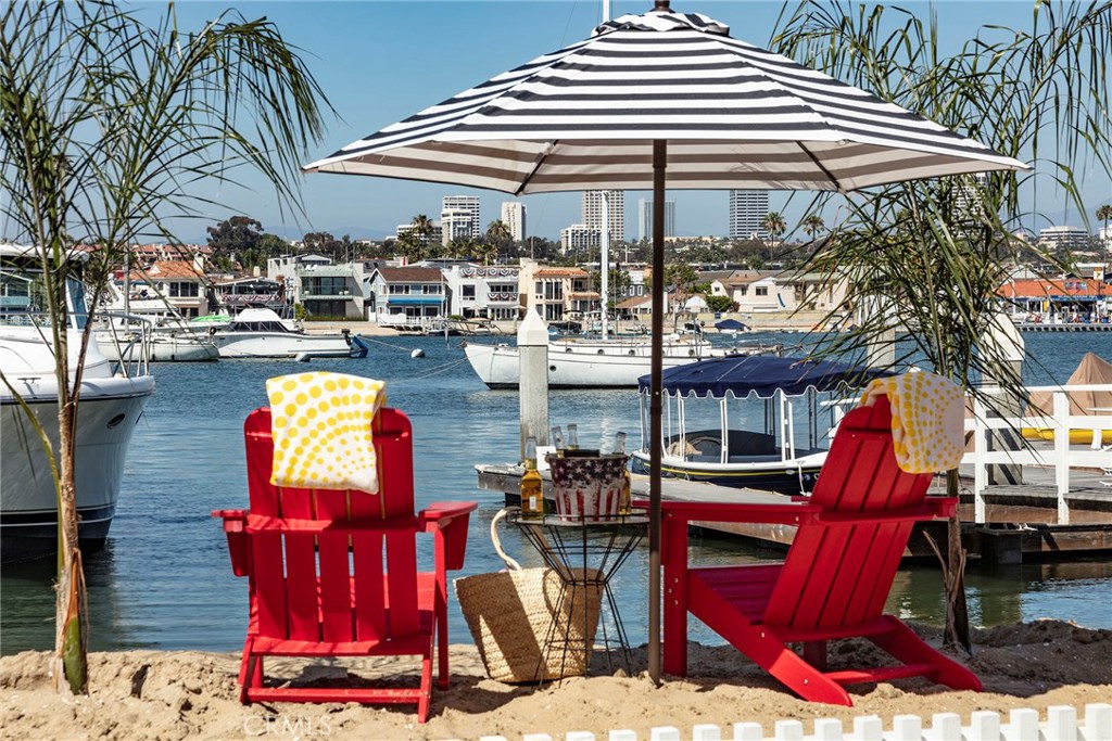 Experience the finest of coastal living in beautiful Newport Beach with the sand at your doorstep, ocean breezes and world-class amenities just minutes away. This prime Balboa Peninsula Bayfront location is situated on a corner double lot with 100’ of private white sand beach, a private dock, and 4 large boat slips. 405 Edgewater Avenue presents a rare opportunity to own a family compound consisting of 2 attached homes that are perfectly positioned with dramatic views of the bay, Balboa Island and Newport Beach city lights. Sited on a 7100’ lot with over 4800’ of living space. The compound has recently been remodeled with hardwood flooring and granite countertops throughout. A large 4 bedroom, 2 bath, owners quarters with floor to ceiling glass and a large front patio. A beautiful 2 bedroom, 2 bath mother-in-law quarters below and 2 attached spacious studios for the kids. 3 enclosed attached garages offering parking for 5 cars and 2 outside designated parking spaces. 3 bayfront patios and seating area on the dock is sure to provide extensive outside entertainment and relaxation areas. This exceptional property would be the perfect primary residence, a wonderful beach house, great investment property or an extraordinary family compound. Don’t miss this once in a lifetime opportunity!