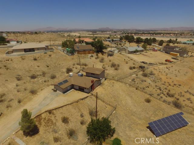 Incredible 3 bedroom, 2 bath Hesperia home!!! This is the steal you've been looking for*** Beautifully remodeled kitchen*** Huge, gorgeous lot on a cul-de-sac*** Home is almost fully electric with solar*** Master bedroom upstairs with a private bathroom, walk-in closet, plus an additional closet*** Detached garage with 220V electricity*** In-door laundry** Enclosed storage area*** Separate living AND family rooms*** Wood burning stove*** This is THE BEST value in the area!!! Association Amenities: None # of RV Spaces: 0 Special Features: PTRYNONE Frontage Type: Dirt Road Lot Location Type: Standard Location # of Attached Spaces: 0 # of Detached Spaces: 2