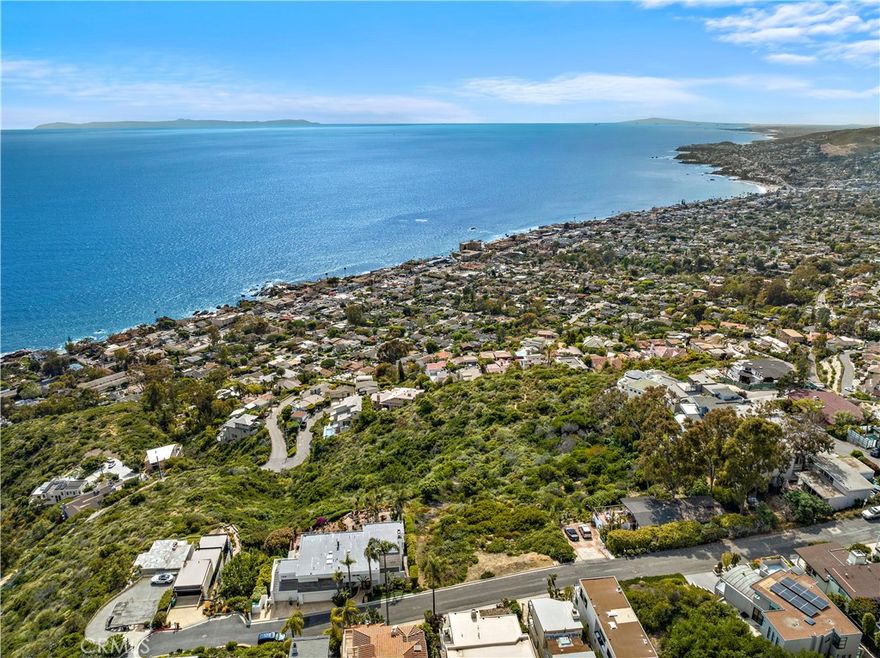 HUGE PRICE REDUCTION! THIS IS THE BEST BUILDABLE LOT IN LAGUNA BEACH! This 13,000 sqft estate size parcel boasts the most incredible ocean, Catalina Island, white water, coastline, and city lights views that you have ever seen. This lot comes complete with permit ready plans, saving you over 3 years in designing and receiving the entitlements! The building permits have been pulled and paid-for which allows you to begin immediate construction on your dream home. The 4,523 sq.ft home was designed by renowned Laguna Beach architect, James Conrad. The stunning contemporary design takes full advantage of the property’s magnificent views. The large outdoor areas, including outdoor kitchen, generous terraces and an estate size pool & spa open to an abundant open space area behind the property. This magnificent property offers lots of privacy. Additionally, the architect will work with the buyer to custom tailor the home to their specific needs. If desired, the home is designed to allow for an easy addition of a two bedroom ADU and home theater. Do not miss this once in a lifetime opportunity to build your dream home in Laguna Beach.