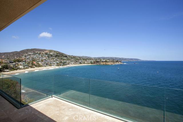 SPECTACULAR EMERALD BAY OCEANFRONT
This stunning oceanfront residence, designed by world renowned architect Paul Williams has recently been exquisitely remodeled and outfitted with many contemporary amenities. The magnificent setting with sweeping ocean views of Emerald Bay's private beach and the gorgeous Laguna Beach coastline to the south, distinguish this property. The parcel of land is exceptional for its location on the end of Emerald Bay point.
There are two limestone decks, one on each level, extending the length of the home, create the ideal environment for entertaining or personal enjoyment of the views and the sounds of the waves brushing the rocks below.
There are two great rooms, one on the main level and one on the lower level, each with fireplace and wetbar. Electronically masterful, the home features sophisticated lighting with art connoisseurs in mind, electrically operated shades and duets and all master switches. Five bedrooms and baths plus a powder, allowing room for any lifestyle. There is an elevator, zoned heating and air conditioning and off street parking for 4 guest cars. Emerald Bay residents enjoy a private beach, parks, tennis, pools. beach volleyball, community center and twenty-four hour guard gated security.