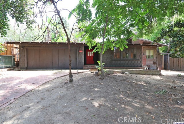 Calling all Investors, developers or owner occupants looking for something truly special to bring back to life and make their own! Don't miss out on this Craftsman architectural beauty w/ unbelievable potential just waiting to be lovingly restored! This estate-like lot sits back from the tree-lined street, located in the prime pocket of Eagle Rock. A long driveway & attached 2-car garage welcome you inside. The spacious interior of the main house features ample spacing & architectural details drenched in natural light; thus an open floor plan can yield innovative use of space & great designs. The living room features a brick fireplace while the den boasts high ceilings & large windows. Several access points lead to the brick courtyard outside and spacious backyard. With the large lot, there's enough room for a pool & then some, in this entertainer's dream. The detached rear guest cottage is a great opportunity to fix up and make available for family, featuring a living room, fireplace, full kitchen, laundry area, & spacious bed & bathroom! The neighborhood is picturesque, prime, & highly desired, w/ conveniences, restaurants, shops, & schools within a stone's throw. Bring your tool belt and imagination for this Eagle Rock gem that is too good to pass up!